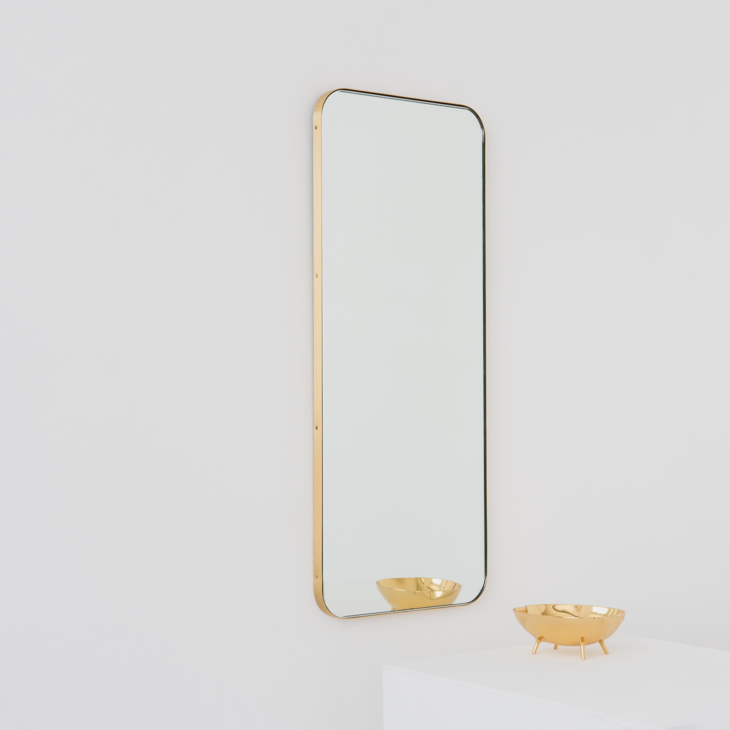 Modern Quadris™ rectangular mirror with an elegant solid brushed brass frame. Designed and made in London, UK. 

Our mirrors are designed with an integrated French cleat (split batten) system that ensures the mirror is securely mounted flush with