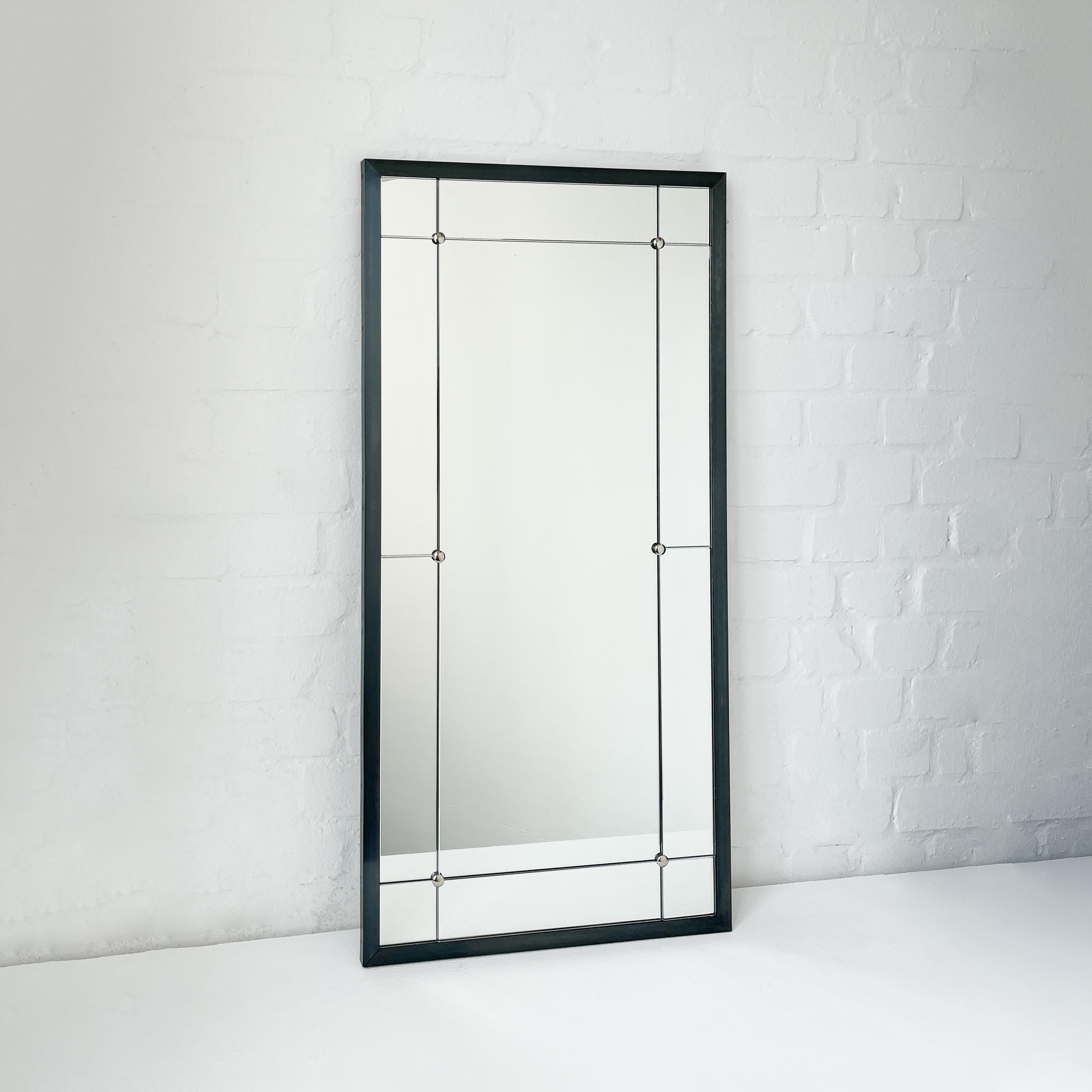 Quadris™ rectangular 11-panelled mirror with a blackened metal frame and metal studs details.

Dimensions: H 97cm x W 48cm x D 1.8cm / H 38.1in x W 18.1in x D 0.7in

Our mirrors are designed with an integrated French cleat (split batten) system that