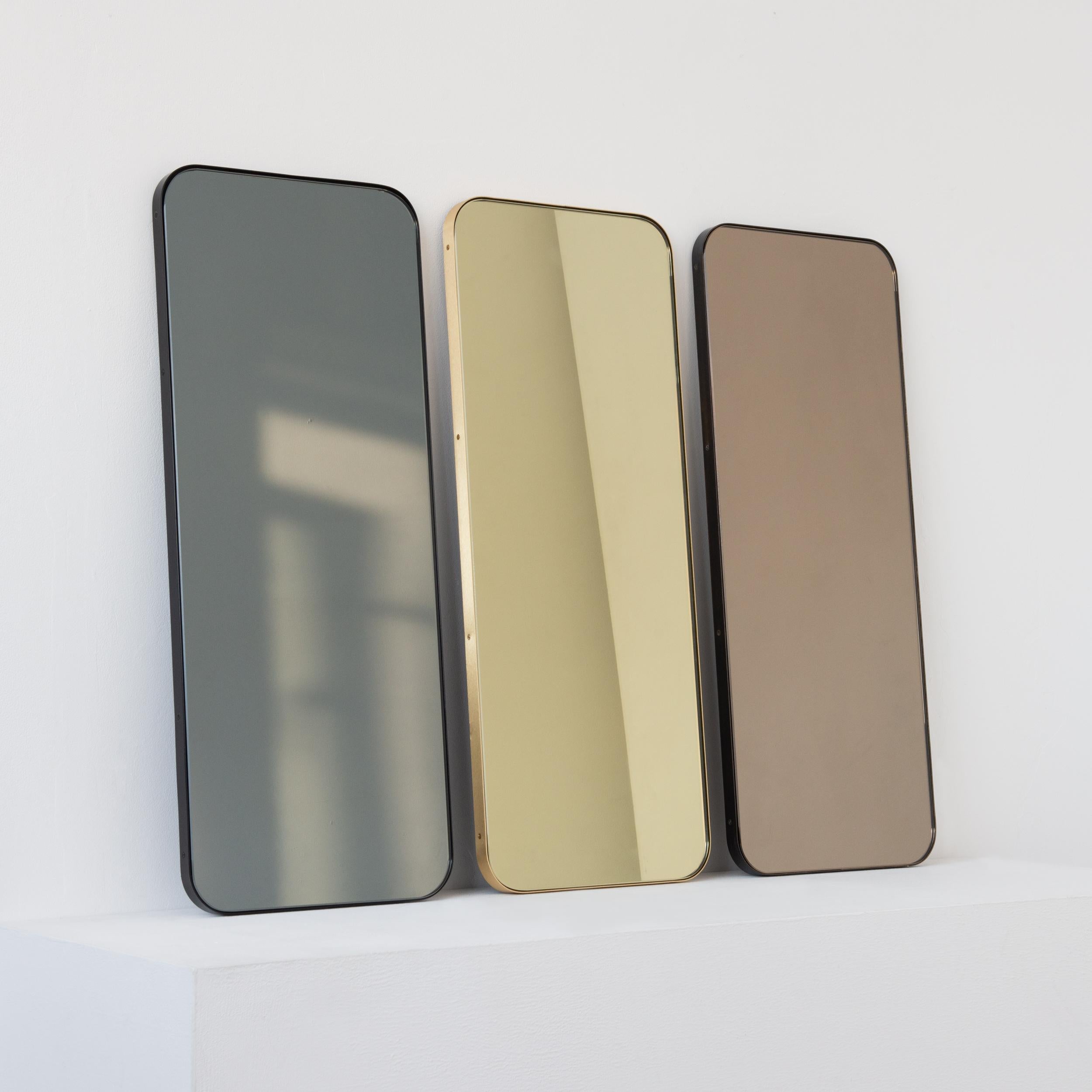 Modern black tinted rectangular mirror with an elegant solid brushed brass frame. Part of the charming Quadris collection, designed and handcrafted in London, UK. 

Medium, large and extra-large (37cm x 56cm, 46cm x 71cm and 48cm x 97cm) mirrors are