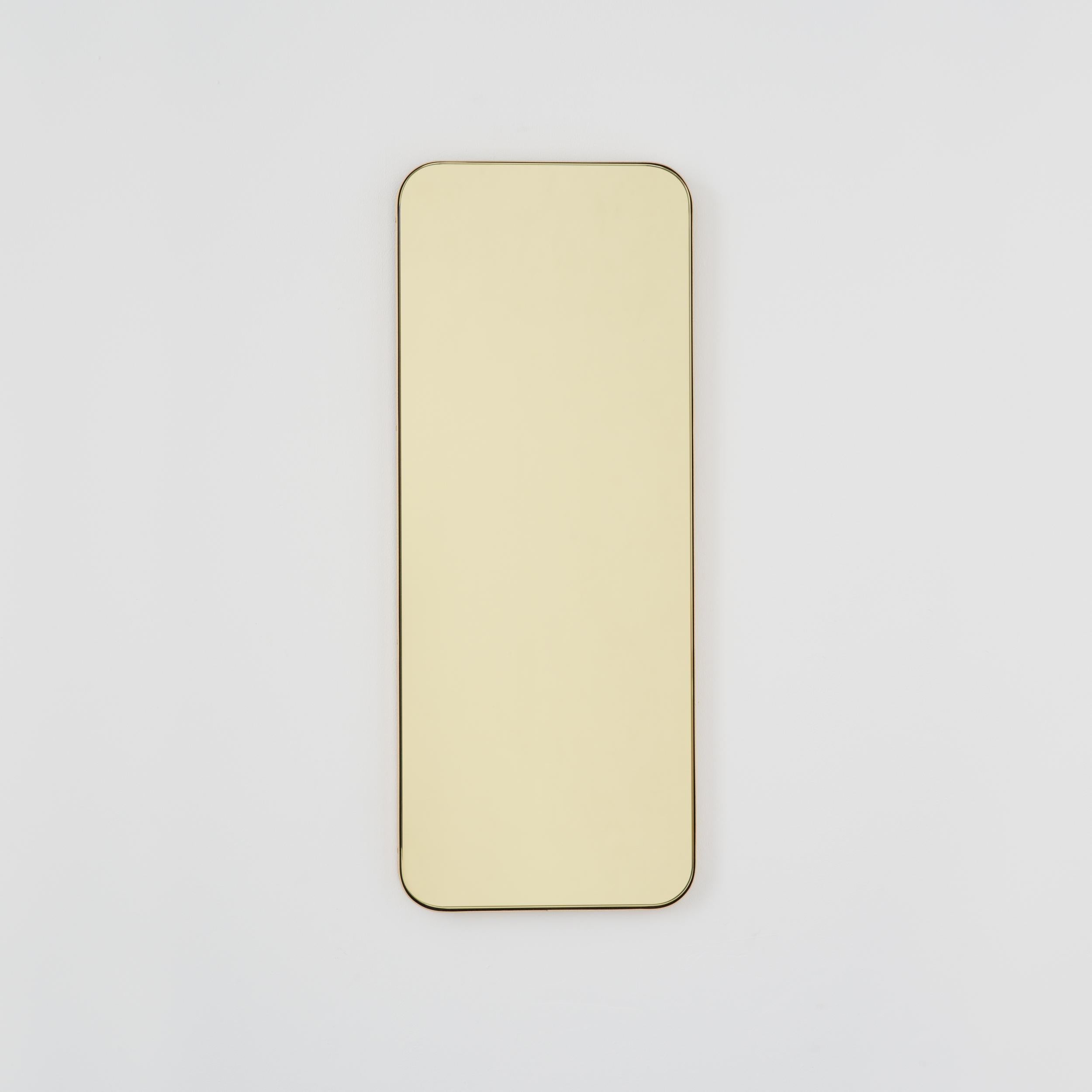 Modern gold tinted rectangular mirror with an elegant solid brushed brass frame. Part of the charming Quadris collection, designed and handcrafted in London, UK. 

Our mirrors are designed with an integrated French cleat (split batten) system that