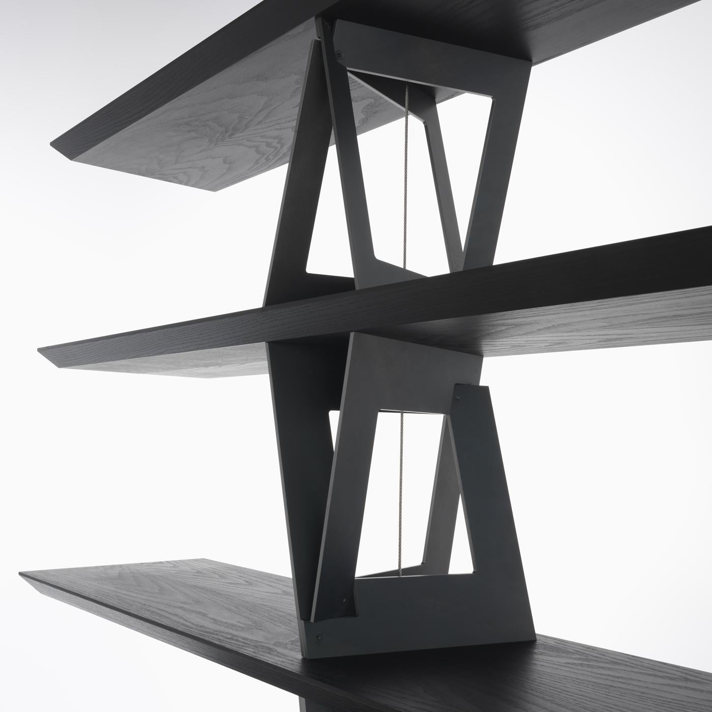 A sculptural work of art of interior design, this bookcase by Dror boasts a captivating and unique silhouette, combining refined materials in a robust yet delicate structure. It comprises plywood and solid ash shelves with internal reinforcements