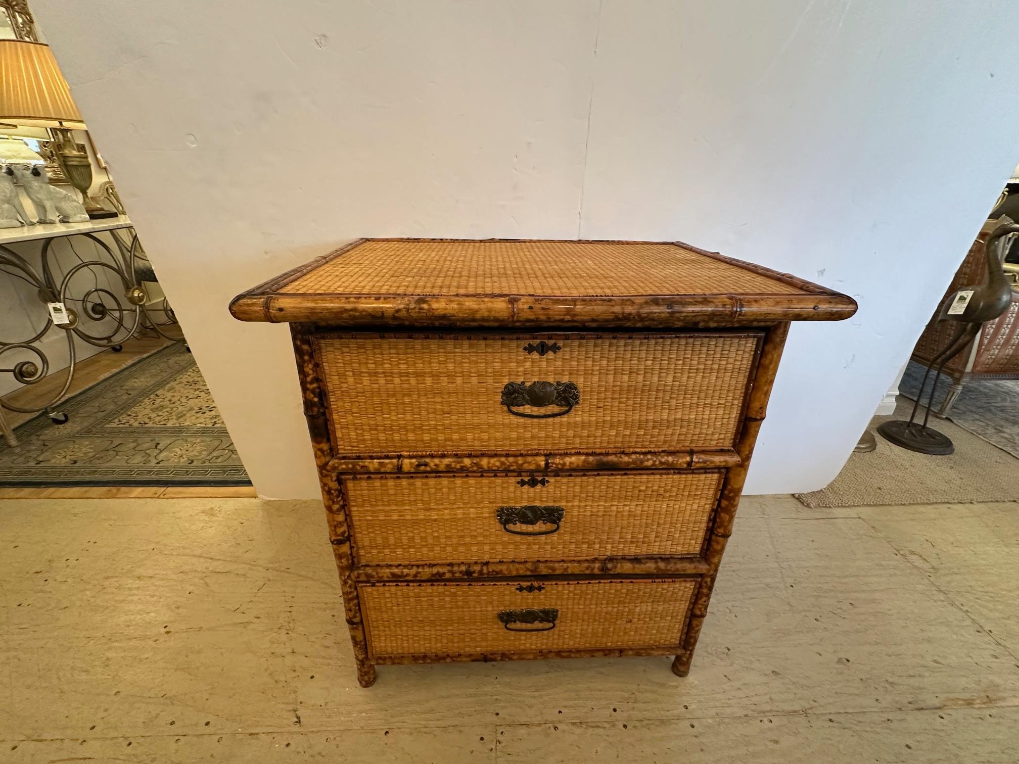 Charming Nantucket grass cloth and split bamboo chest of drawers with original hardware.

SW
