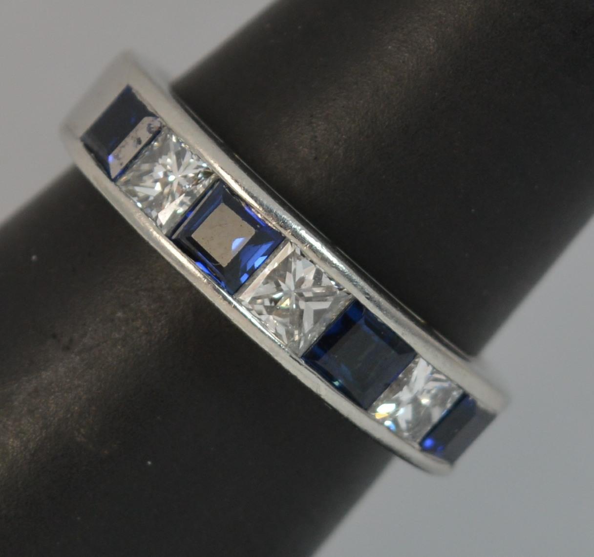 A well made and substantial cluster ring in solid hallmarked platinum.
Ring Size; N 1/2 UK, 7 US
​Designed with alternating natural princess cut Sapphires and Diamonds to form a seven stone half eternity or stack ring.

As confirmed to the shank, a
