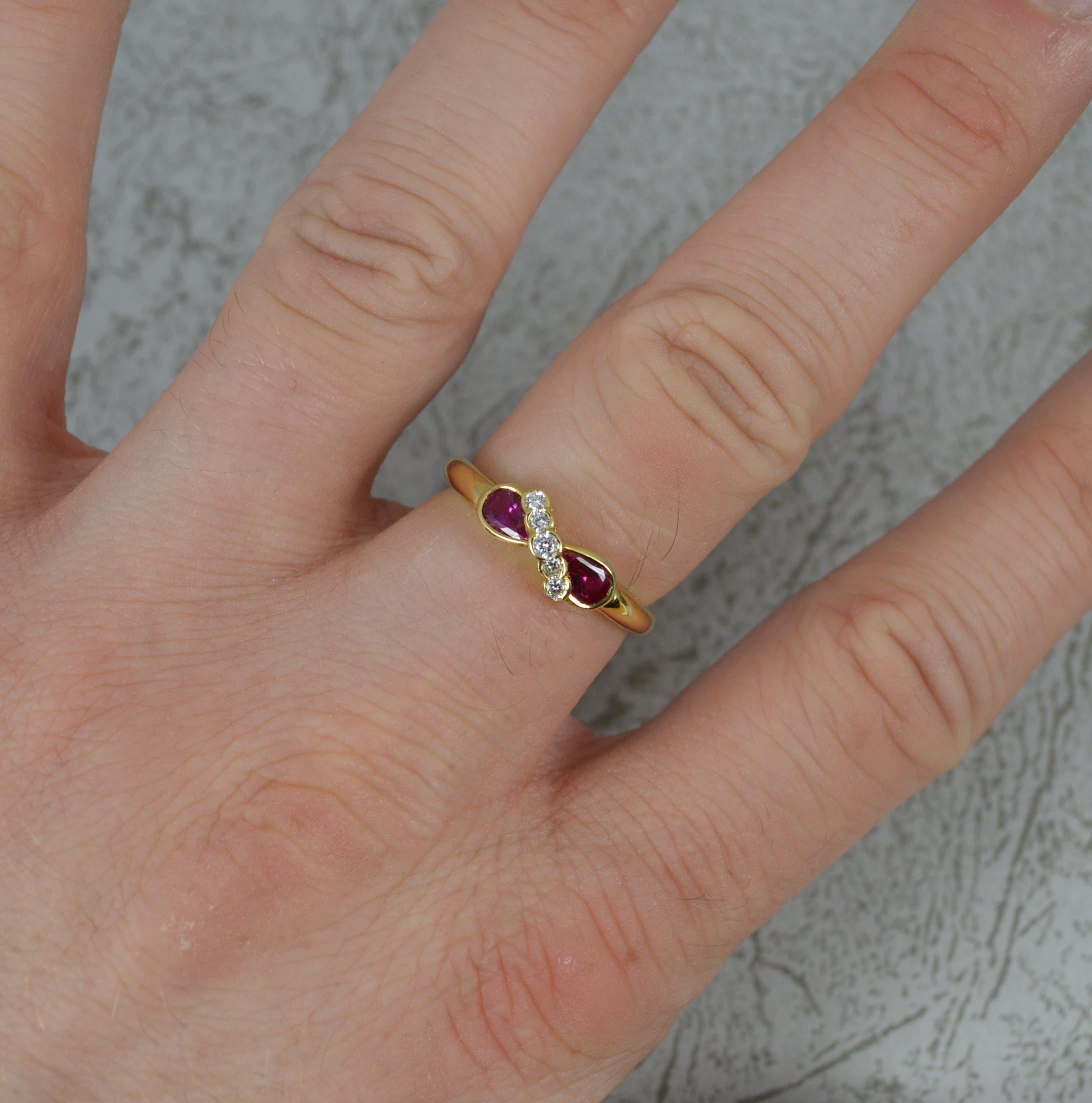 A beautiful Ruby and Diamond cluster ring.
Solid 18 carat yellow gold example.
Designed with two pear cut rubies and five round brilliant cut diamonds set in between on a diagonal.
12mm x 5.5mm cluster head.

CONDITION ; Excellent. Clean and