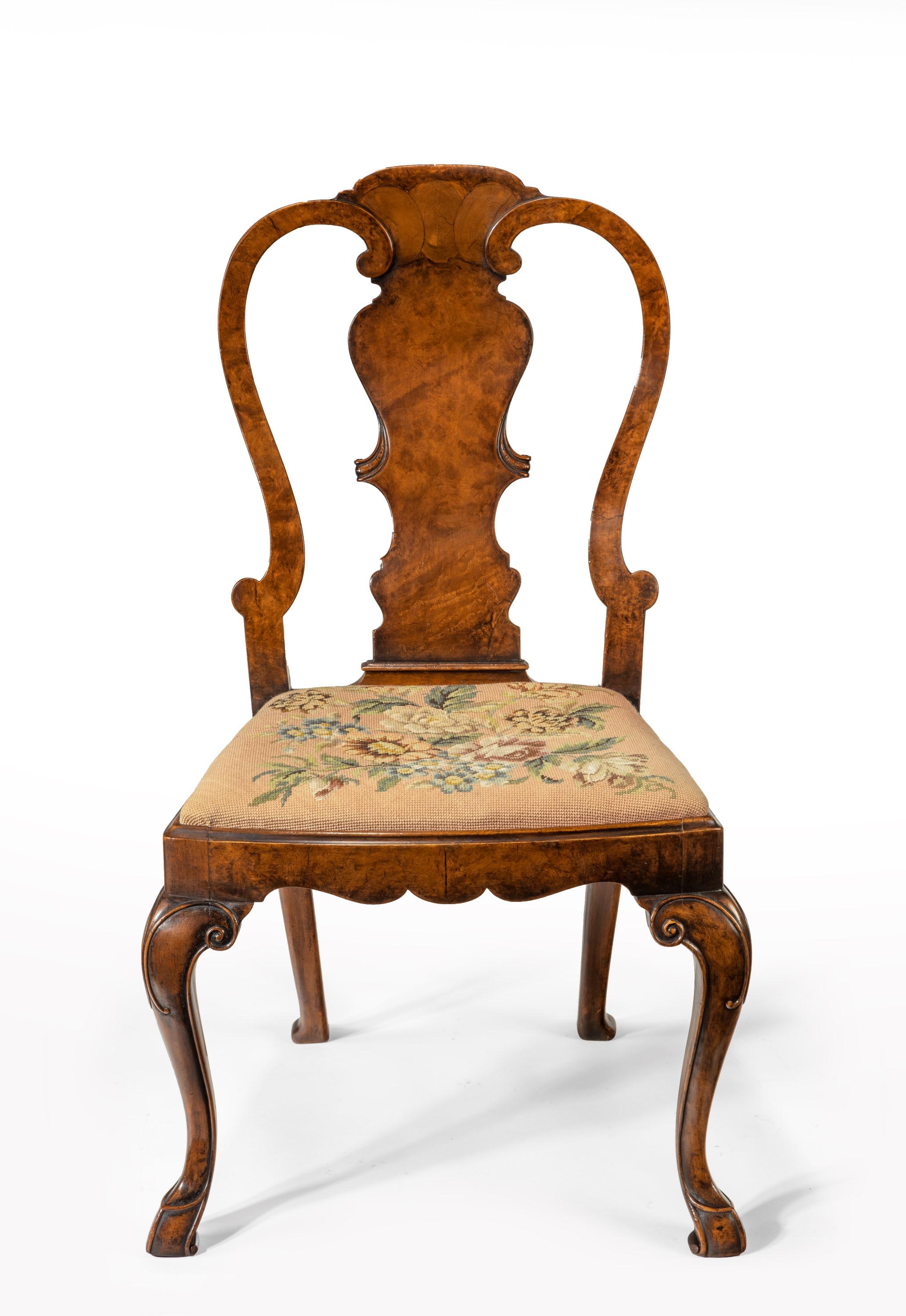A fine quality 19th century burr walnut side chair with original needlework drop in seat in the George I style.

English, circa 1880.

The shaped top rail having an oyster veneer detail to the centre above a vase shaped splat flanked by