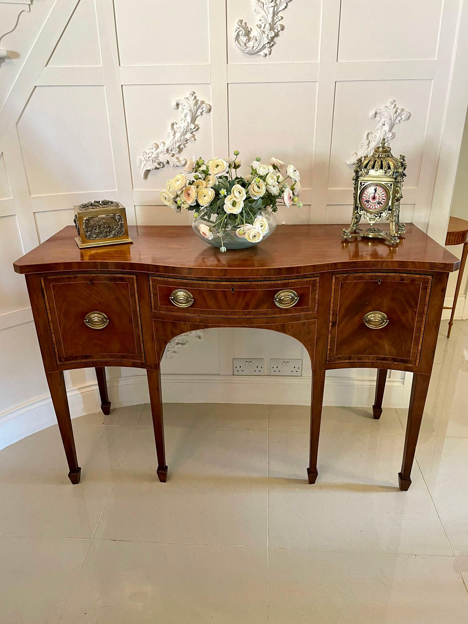 Date 1870 Quality antique 19th century mahogany serpentine fronted sideboard having a quality mahogany serpentine fronted shaped top with satinwood inlay stringing, shaped central drawer crossbanded in satinwood with original oval brass handles