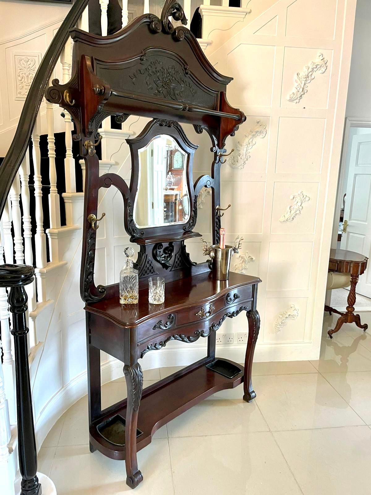 
Quality 19th Century Victorian antique carved mahogany hall stand with a superb carved top, shaped mirror to the centre, original brass hooks, one drawer, shaped stick stand, supported by carved shaped cabriole legs united by a shaped under-tier