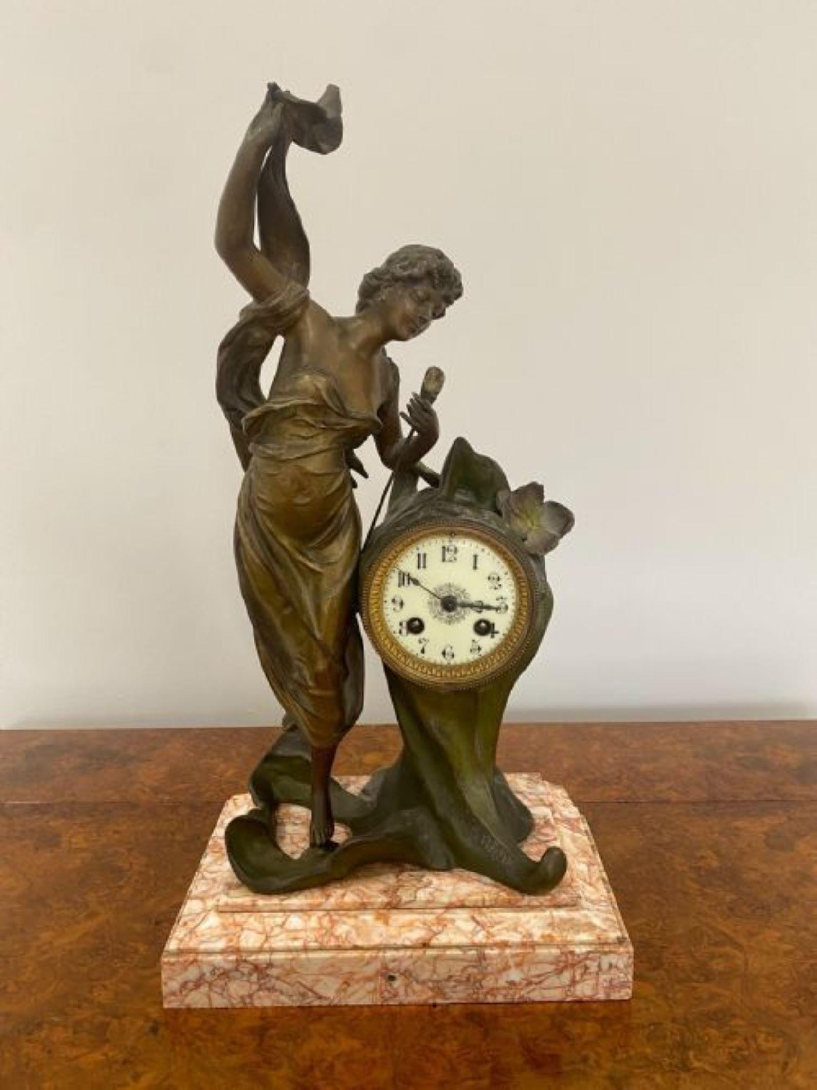 Quality Antique Art Nouveau French L'AURORE mantle clock, having a beautiful lady in bronze holding a flower standing on a marble base, 8 day mantle clock striking on a bell with the original key. L'AURORE signature. Minor chip in the marble base as