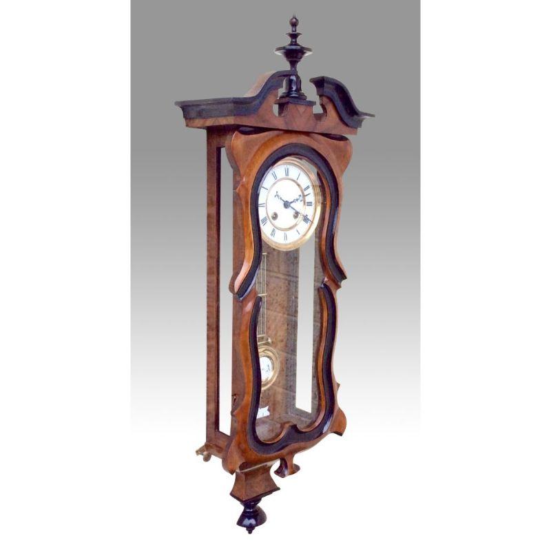 Beautiful Antique black & walnut 

Spring Vienna clock by Gustav Becker{number 426273} 
Strikes Hour & Half Hour 
36ins x 11ins x 6ins Circa 1885 
Excuse reflections on glass 
 
Declaration: This item is antique. The date of manufacture has