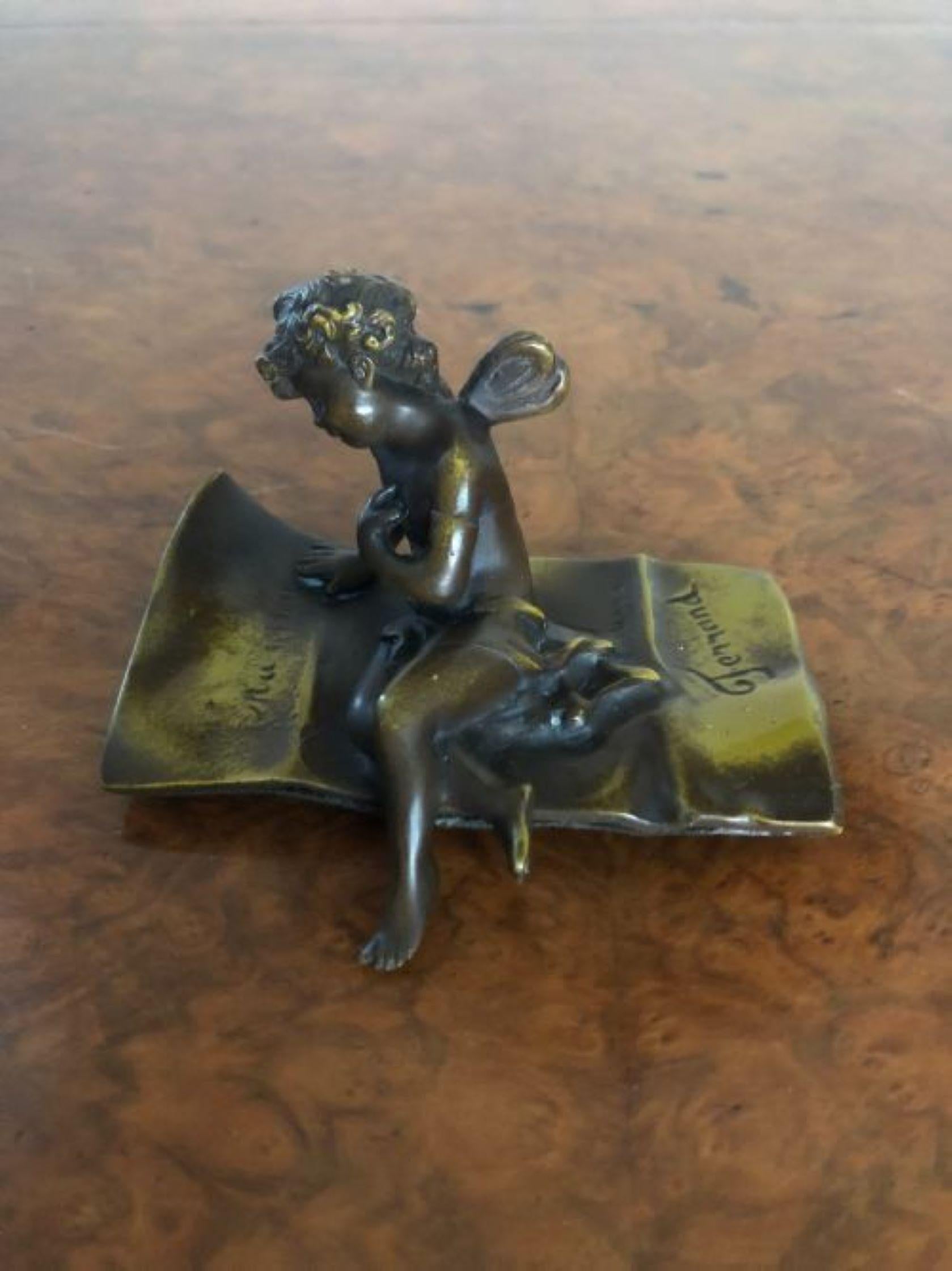 Quality Antique bronze cupid figure signed Ferrand. Quality bronze figure of a cupid setting on a rug signed Ferrand for Ernst Justin Ferrand.
