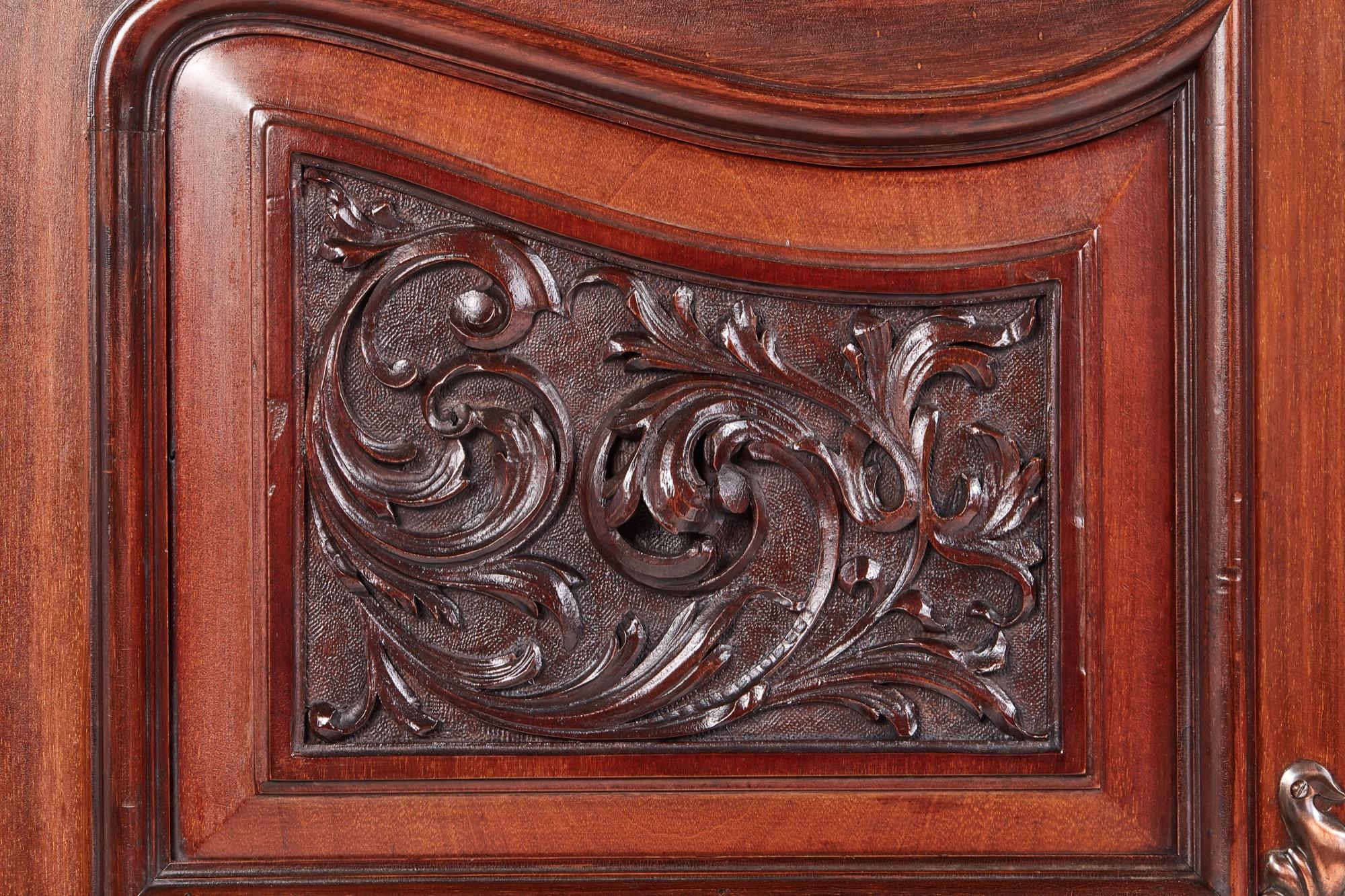Quality antique carved mahogany sideboard by Maple & Co. The striking base has two central drawers and recessed shelf below flanked by a pair of carved panelled doors which enclose shelves and cellarette. This grand piece is supported on squat