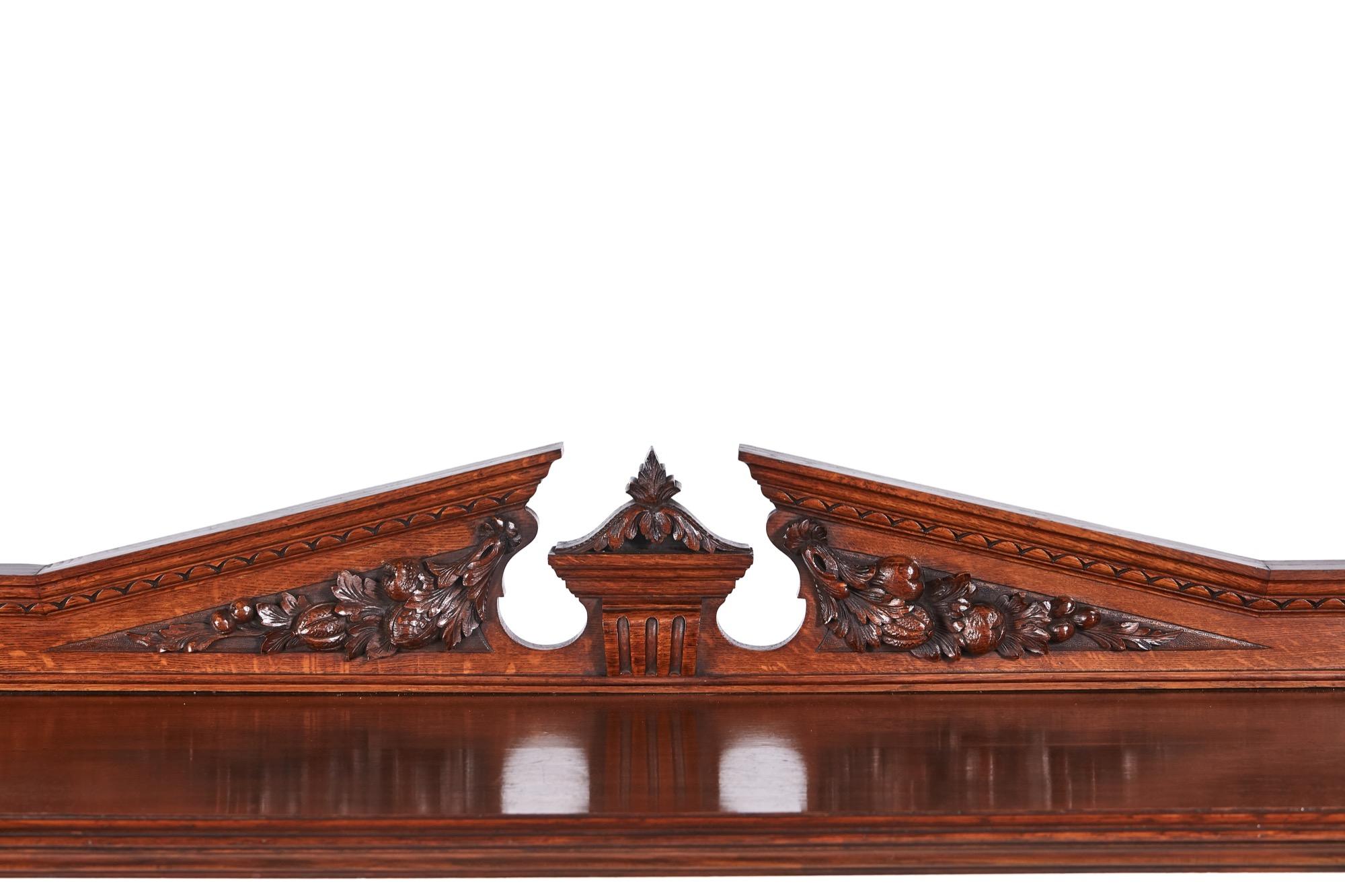 This is a quality antique carved oak dumbwaiter which has a pomegranate carved broken arch pediment and three tiers between fluted carved columns, raised on bun feet with original castors.



 