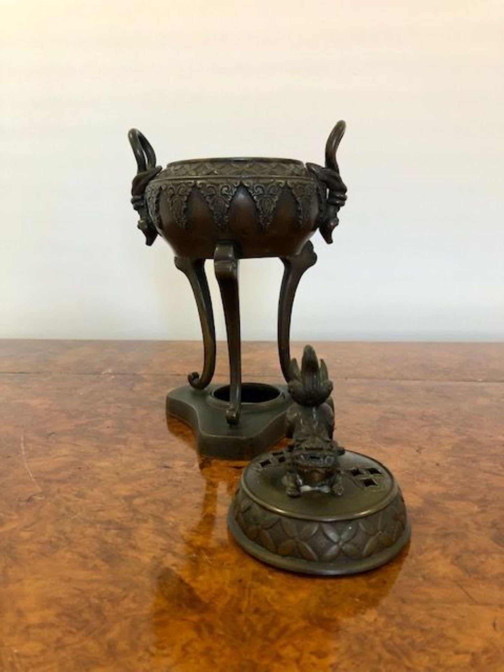 Quality antique Chinese bronze incense vase. Having a lift of ornate lid with a dog above a ornate vase with quality handles raised on three legs and a platform shaped base. 