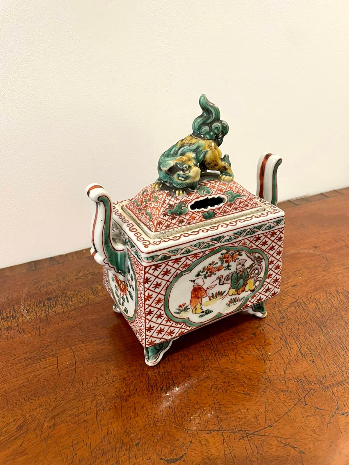 Quality Antique Chinese hand painted vase and cover having a rectangular shaped vase with shaped handles and a lift off lid with a Chinese dog of foo to the top in wonderful hand painted panels in red, green, yellow and white colours.
 
Measures: