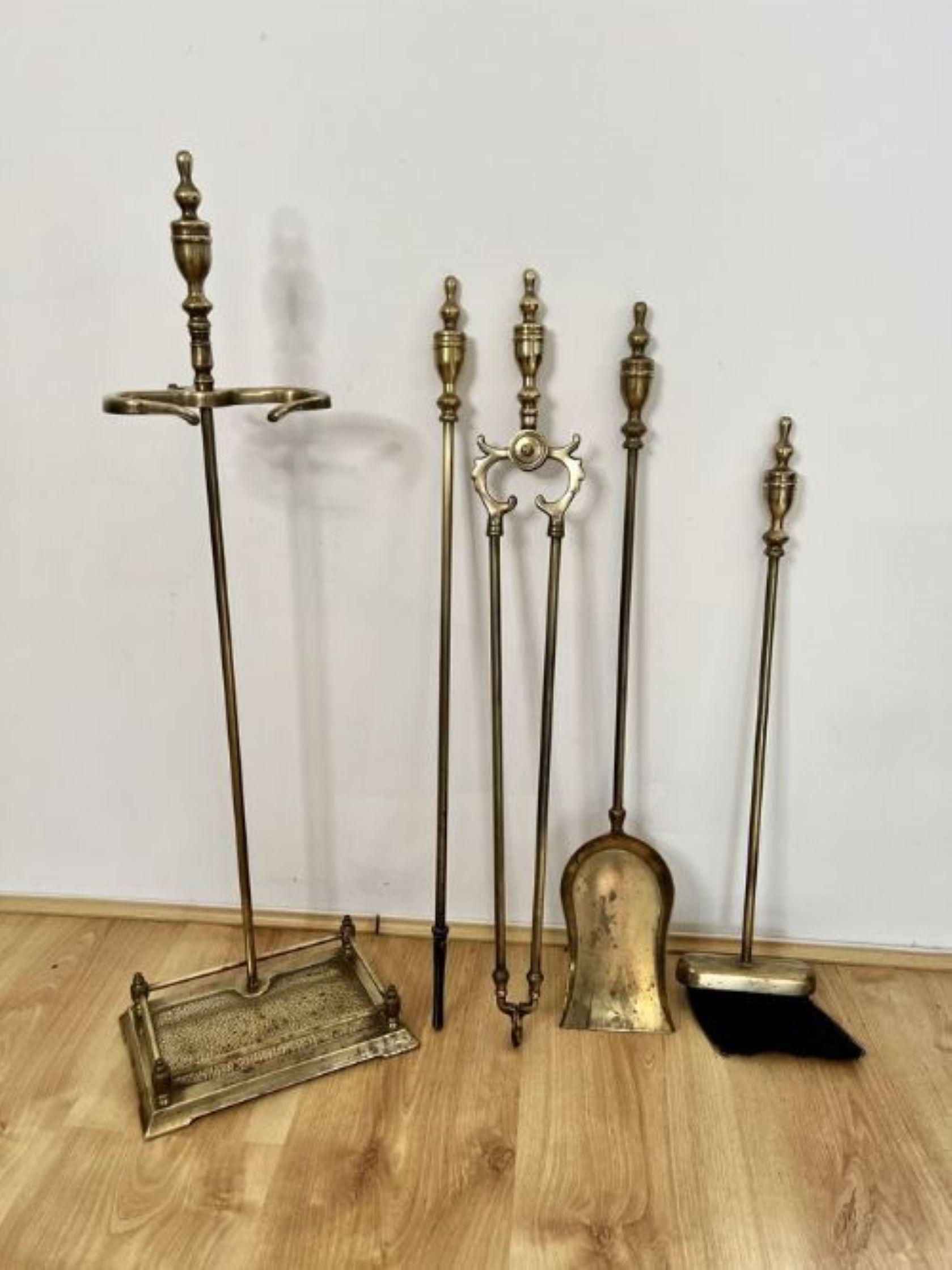 Quality antique Edwardian brass companion set and stand having a quality antique Edwardian brass stand with a pair of brass fire tongs, a brass shovel, a brass brush and a brass poker with shaped brass handles.