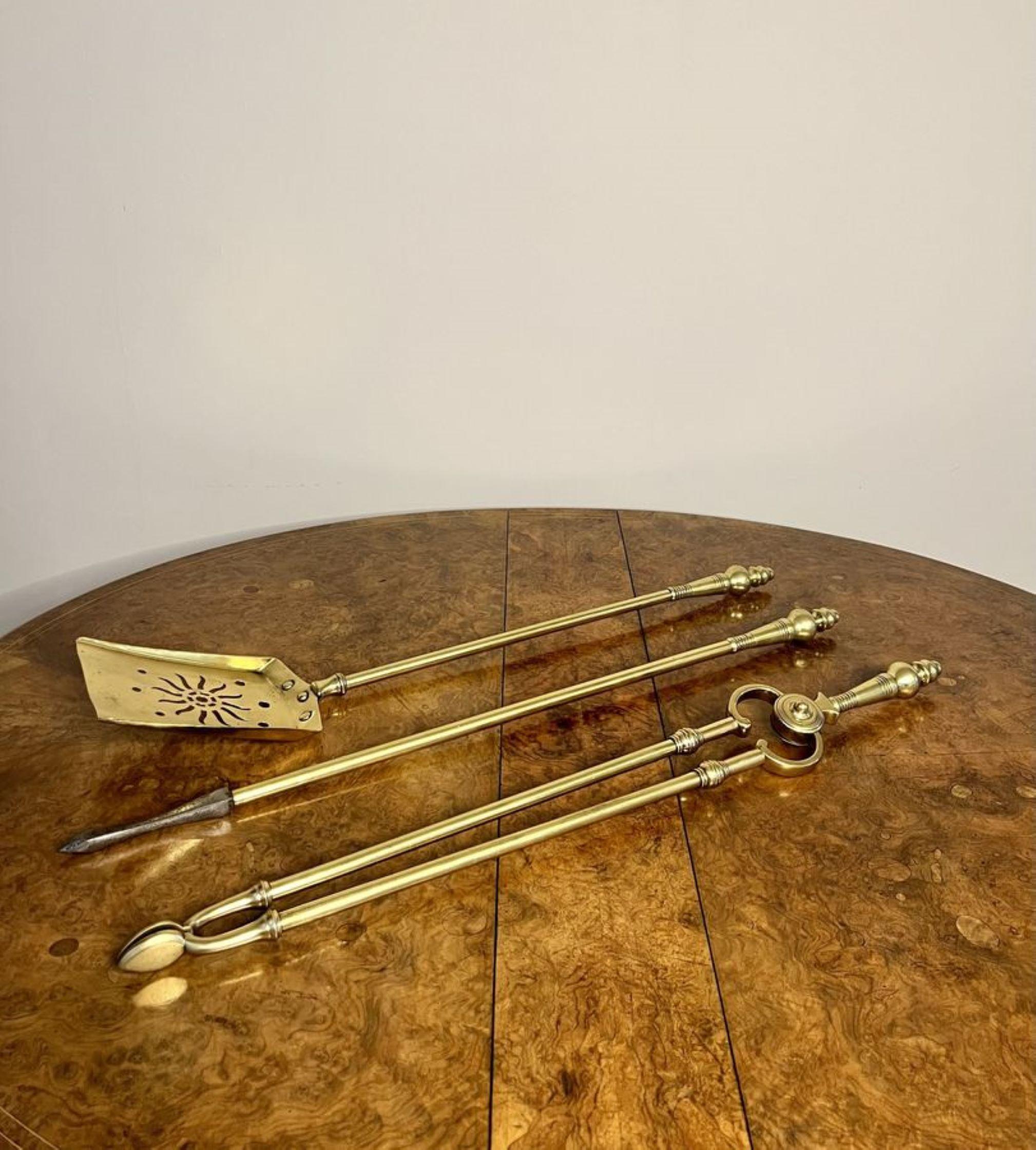 Quality antique Edwardian brass fire irons having a quality set of fire irons with circular detailed handles consisting of a shovel, poker and a pair of tongs.

D. 1900