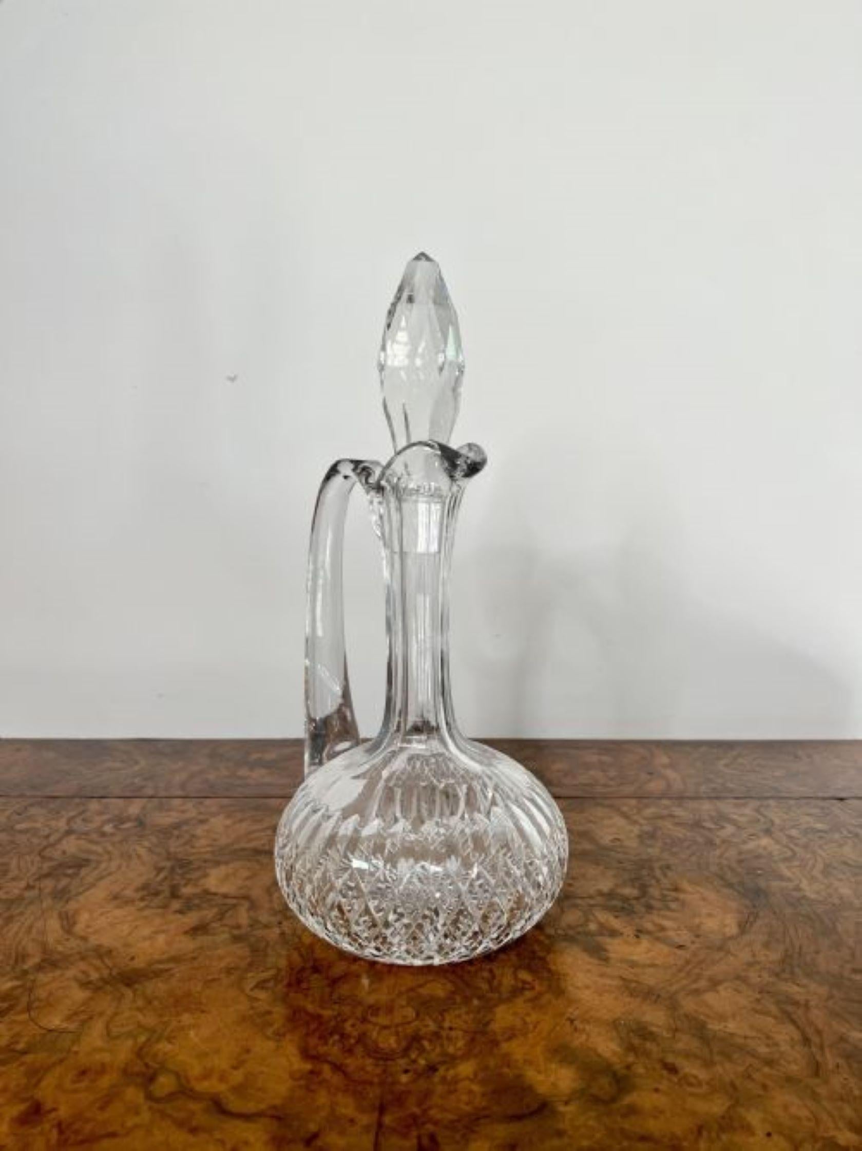 Quality antique Edwardian cut glass ewer having a quality antique Edwardian cut glass ewer with a shaped handle to the back and the original cut glass stopper.