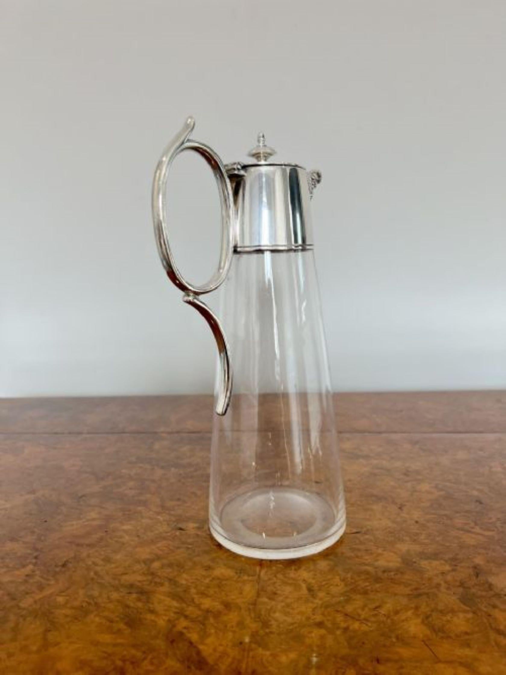 Quality antique Edwardian glass and silver plated claret jug having a quality antique Edwardian claret jug with a silver plated top, wonderful silver plated shaped handle with a fantastic ornate spout about a clear glass body. 
