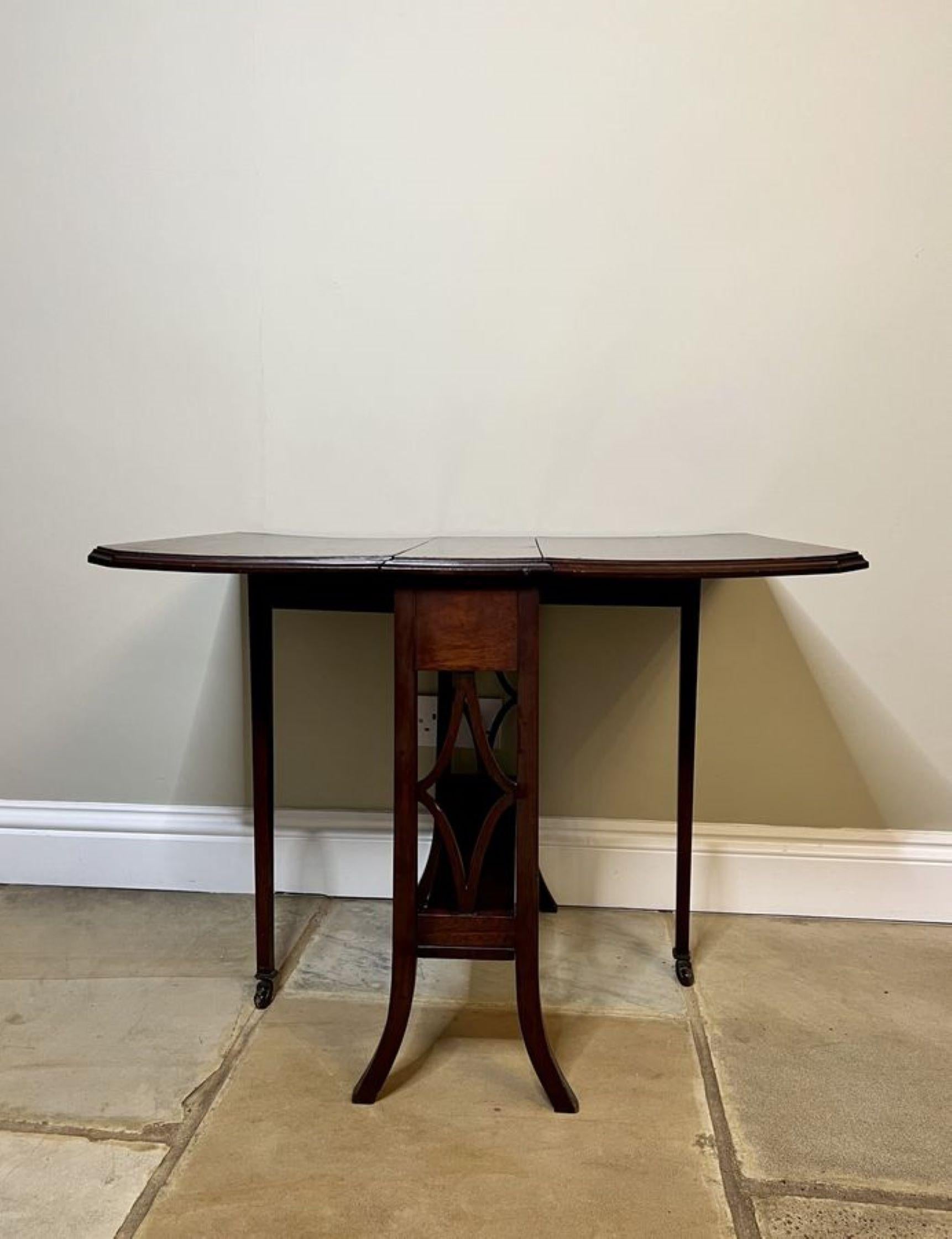 Quality antique Edwardian inlaid mahogany Sutherland table having a quality mahogany top with two drop leaves crossbanded in satinwood, swing out gatelegs supported by shaped mahogany legs with the original castors united by a mahogany undertier.