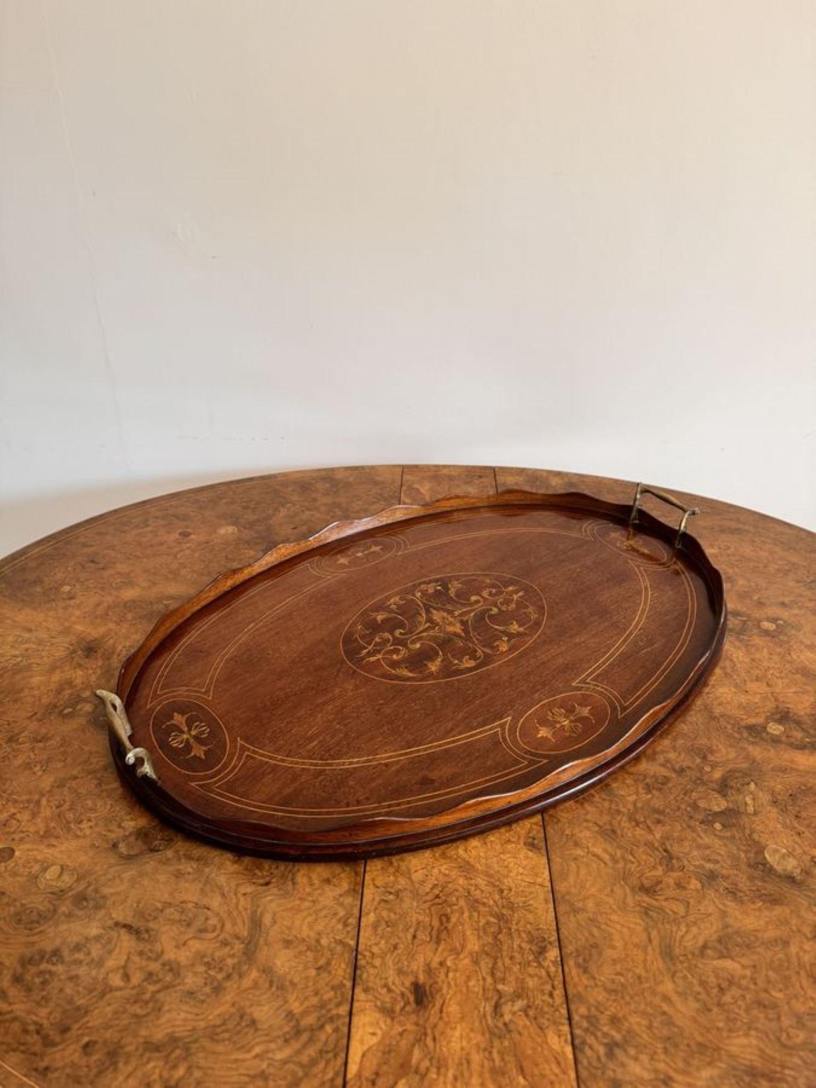 Quality antique Edwardian mahogany inlaid oval tea tray having a quality antique Edwardian oval inlaid mahogany tea tray with wonderful inlay to the centre of the tray with a wavy gallery edge and original brass carrying handles to both sides.

D.
