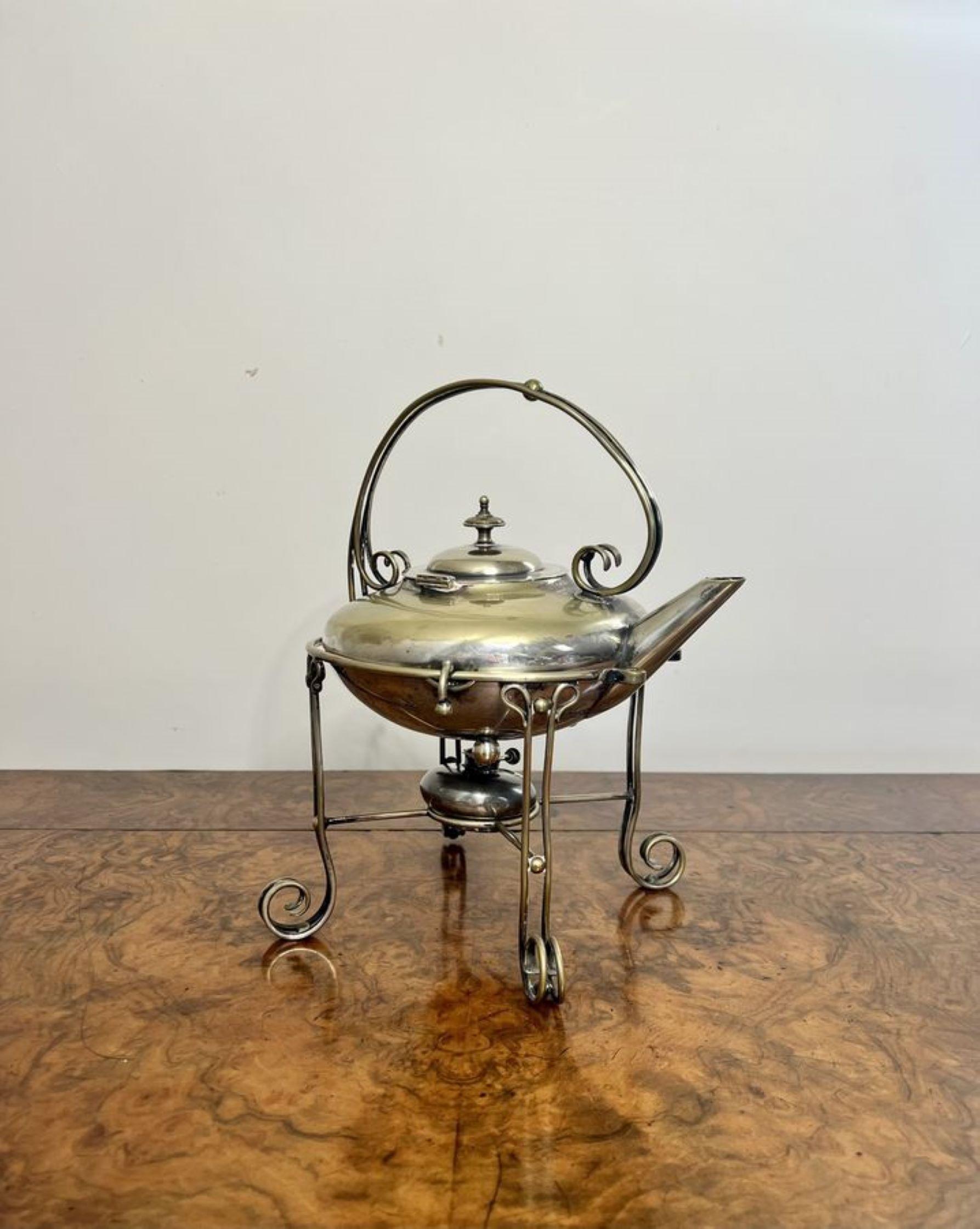Quality antique Edwardian silver plated spirit kettle having a quality silver plated kettle raised on an ornate silver plated stand, with the original burner, standing on four shaped feet.

D. 1900