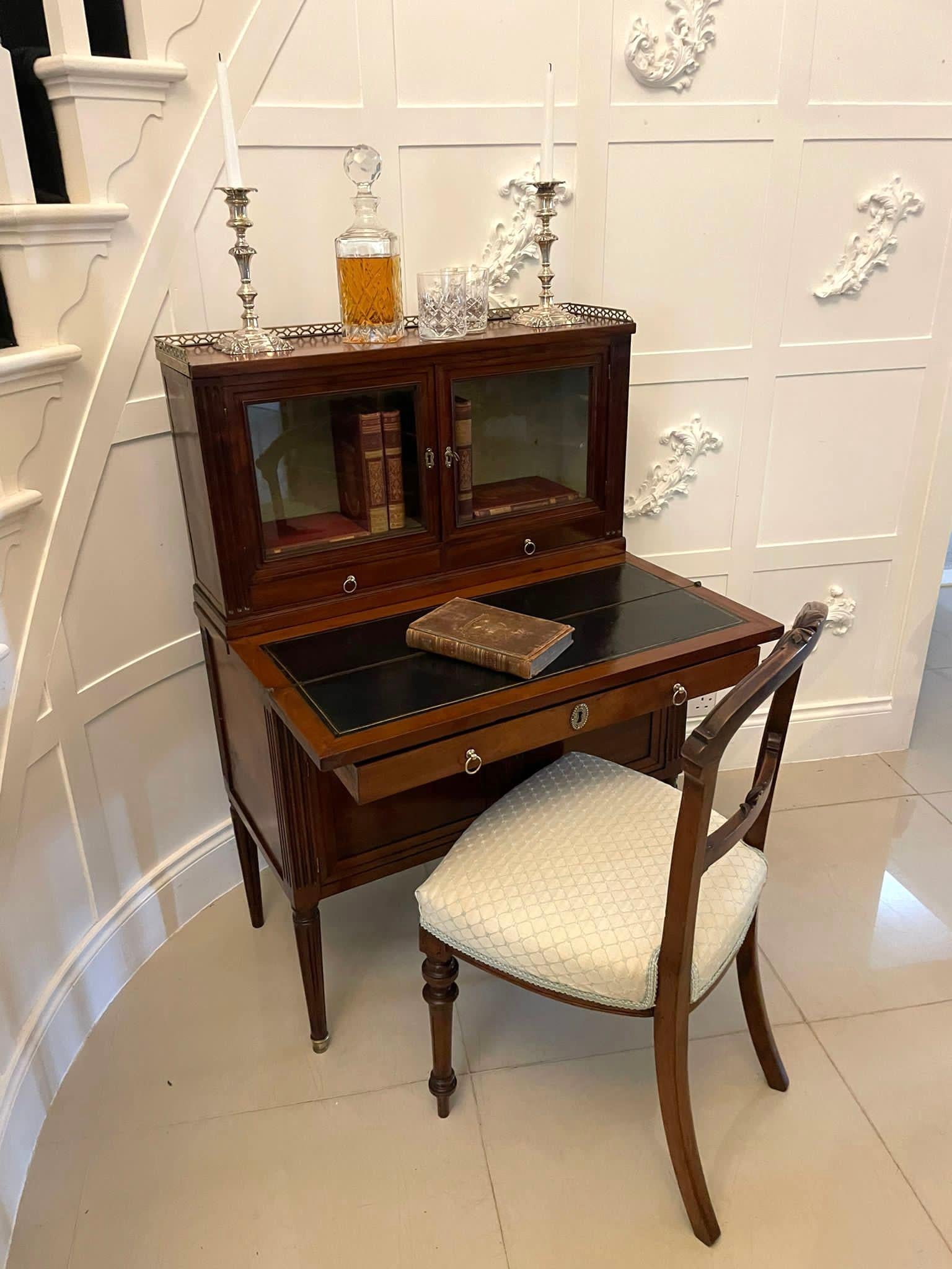 Quality antique French mahogany fold down desk having the original pretty brass gallery, two glazed doors, two drawers with original brass handles. The base boasts a fold down writing surface, one long drawer with original brass handles, two