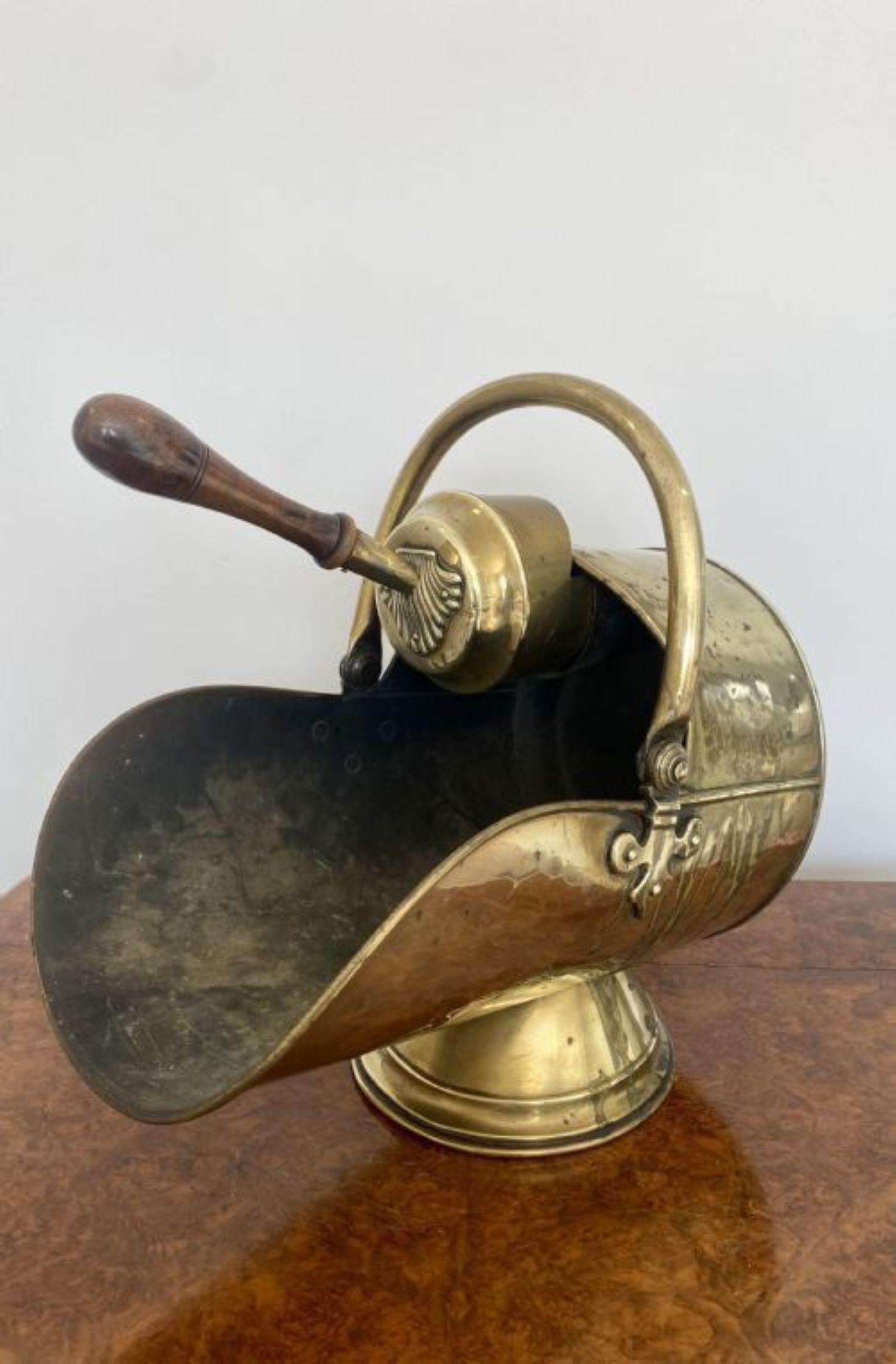 Quality antique George III brass helmet coal scuttle with original shovel having a shaped movable handle 