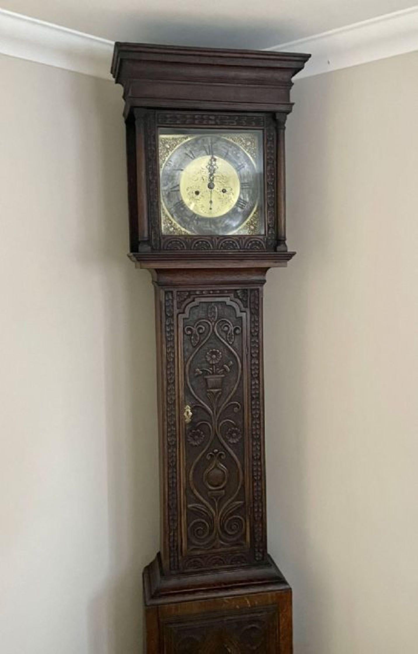 Quality Antique George III Carved Oak Brass Face Longcase Clock. Having a square brass dial with original hands with an 8 day movement striking the hour & a half bell, shaped cornice above the glass door flanked by turned columns above a long carved