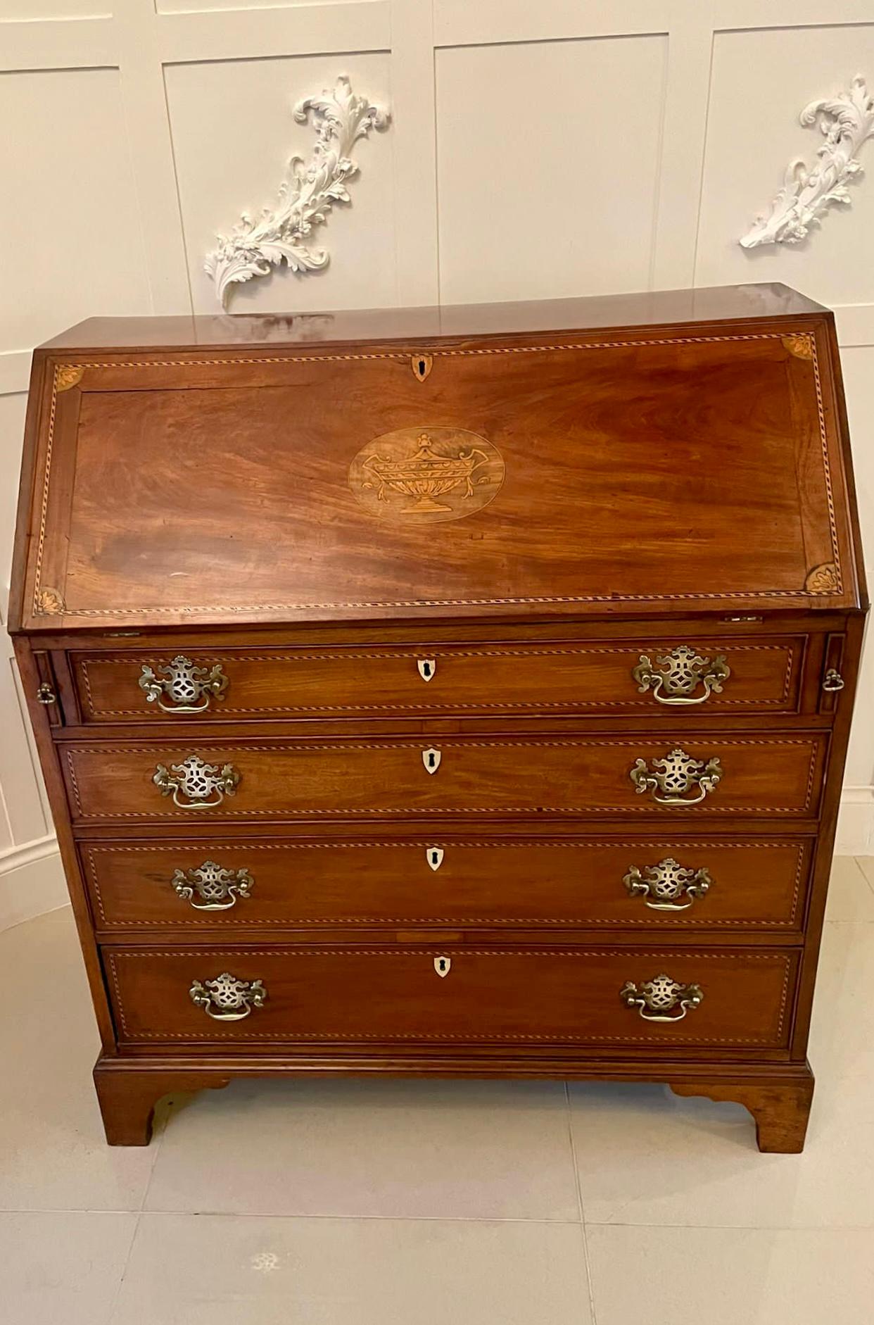 Quality antique George III mahogany inlaid bureau having a quality inlaid fall with very attractive ebony and boxwood stringing and four inlaid shells to the corners with an inlaid satinwood urn to the centre. The fall opens to reveal a green baize