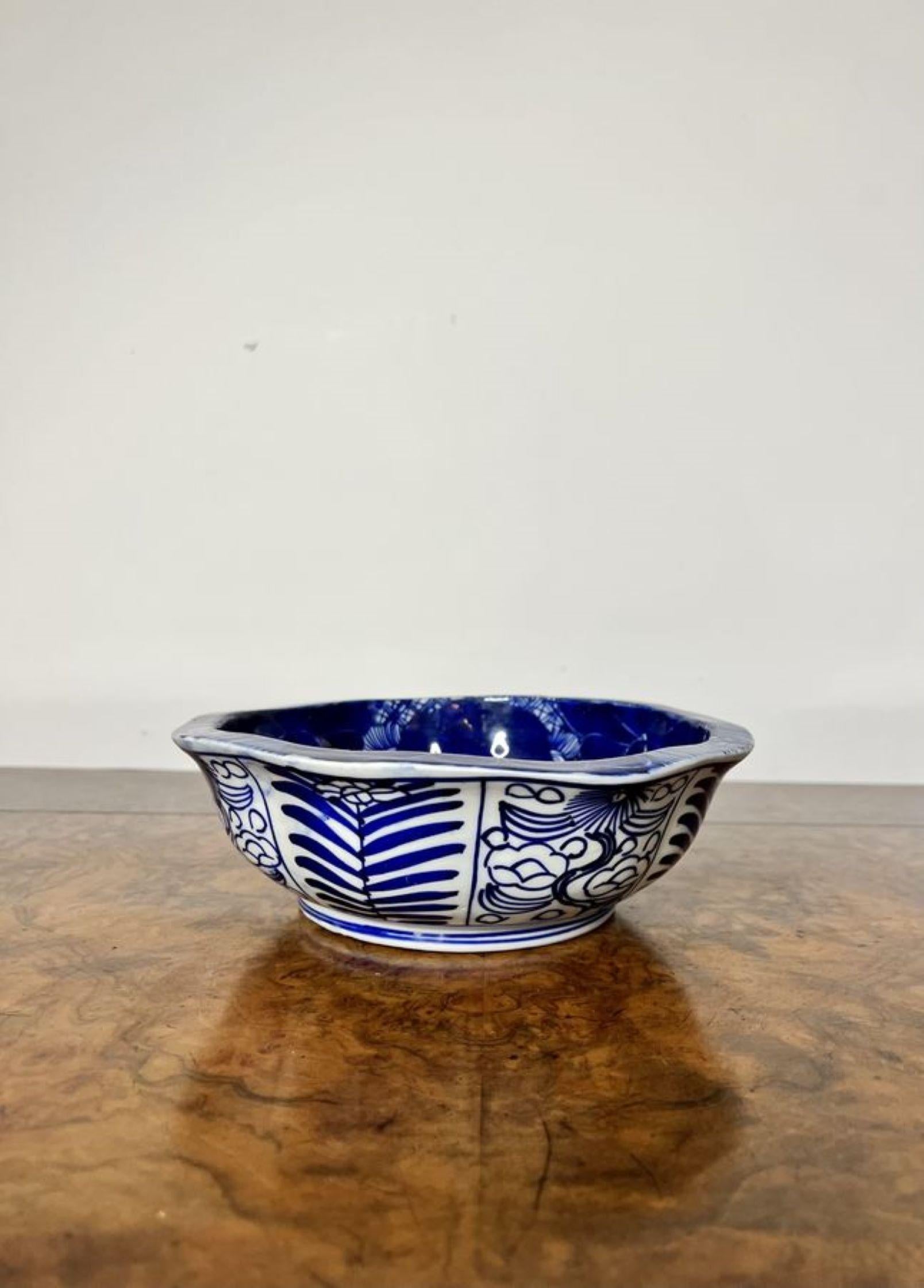 Quality antique Japanese 19th Century blue and white porcelain bowl, circular in shape with a lobed top, decorated throughout in hand painted blue and white colours with panels of flowers and patterns and a centre scene to the inside of the
