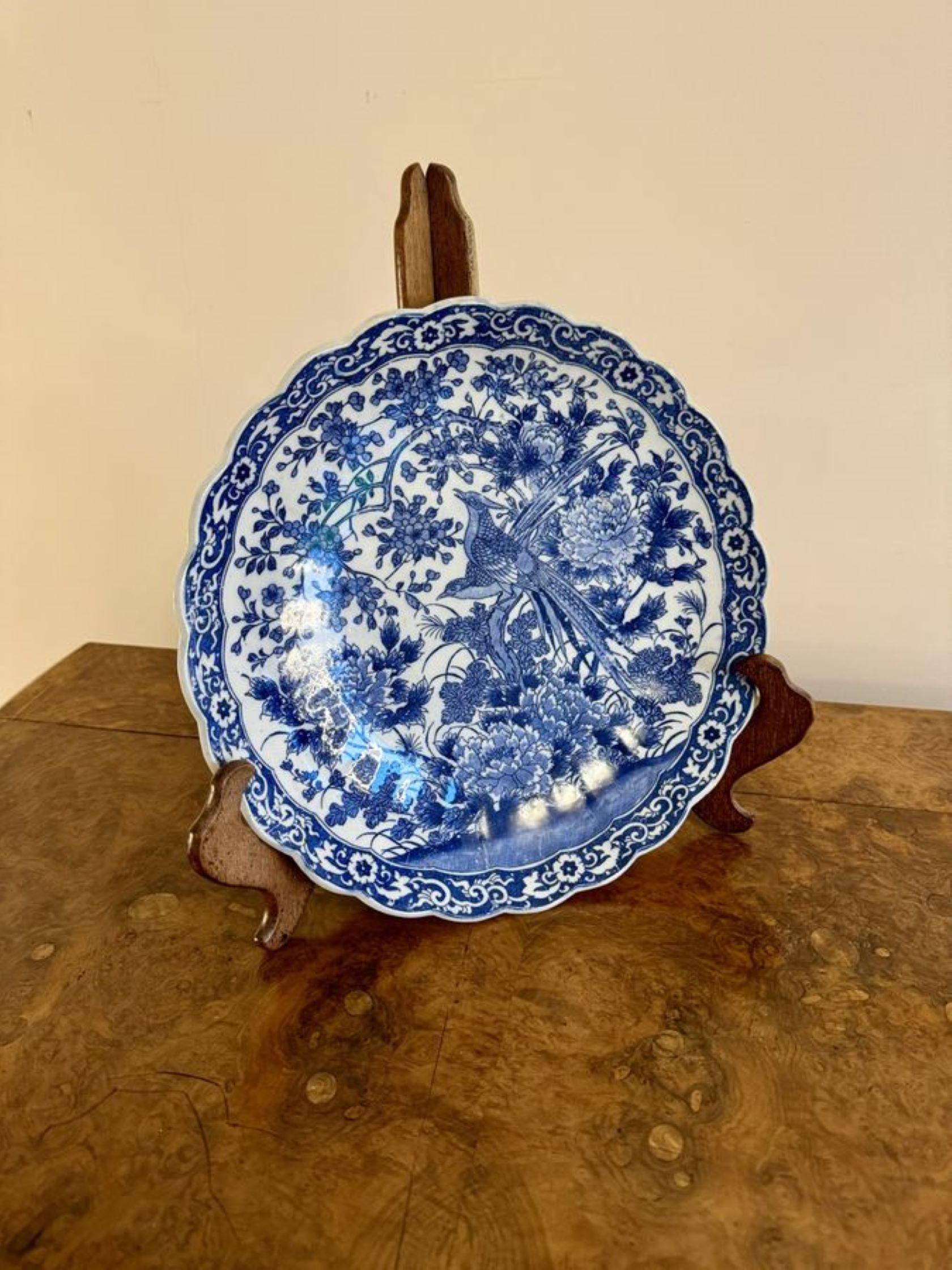 Quality antique Japanese blue and white imari scalloped edge plate, having a quality antique Japanese imari blue and white plate, hand painted in wonderful blue and white colours decorated with two birds on a tree surrounded by flowers, leaves,