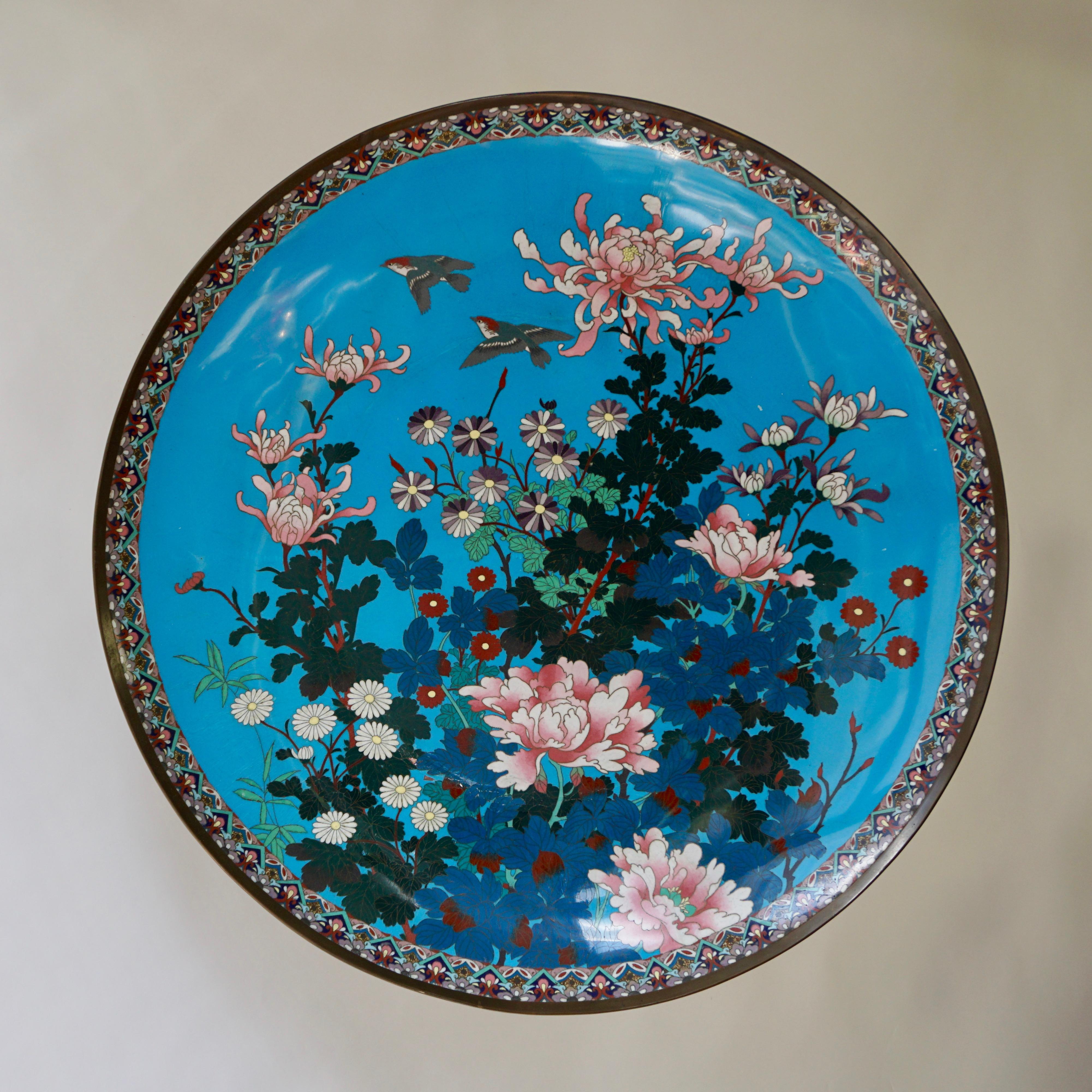 Large quality antique Japanese cloisonné plate, having birds, trees and flowers on a blue back ground 
Good vintage condition 
Measures:
Diameter 60 cm.
Depth 8 cm.
 
