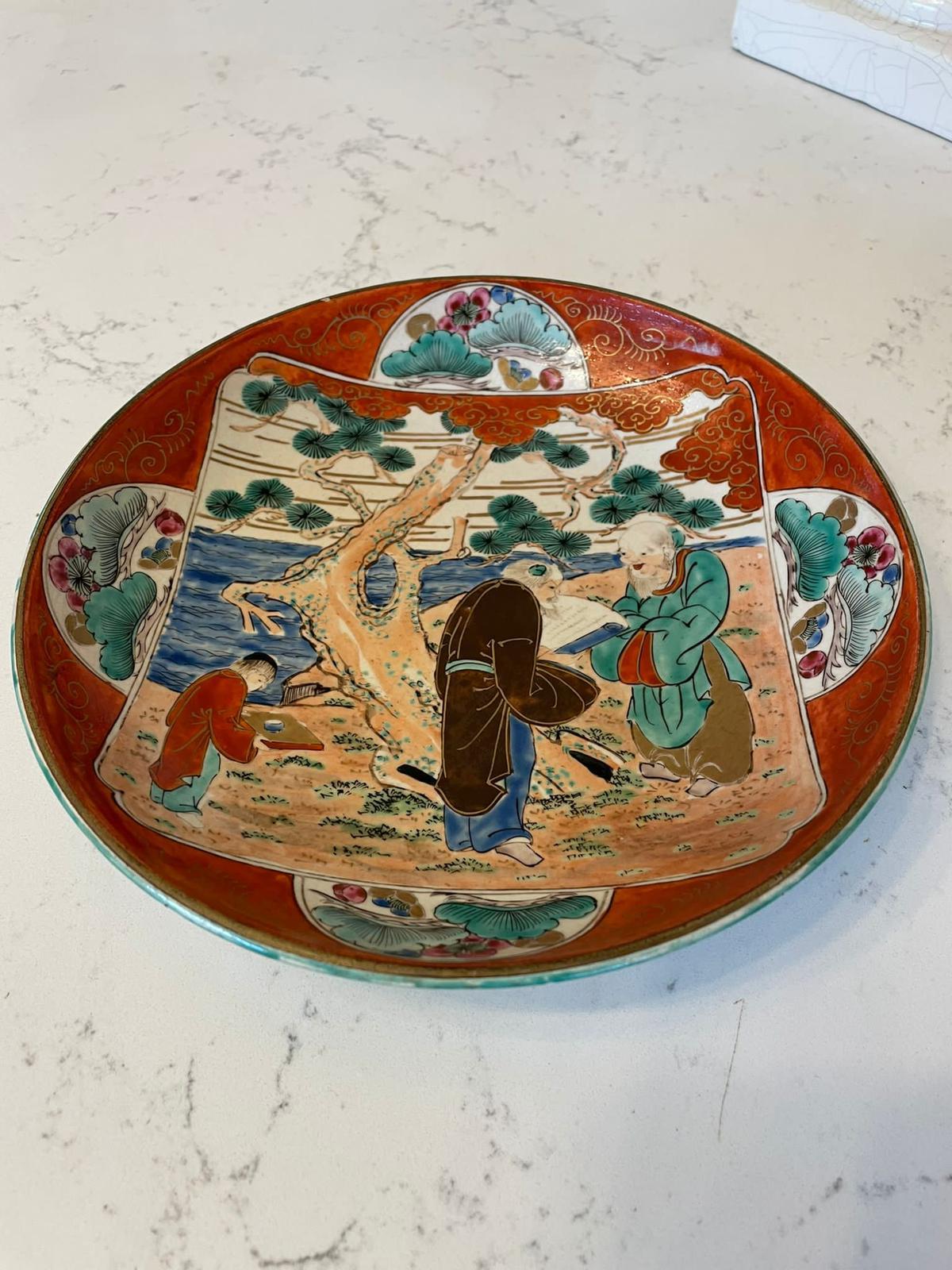 Quality antique Japanese hand painted kutani shallow bowl having a large quality hand painted panel to the centre depicting a tree, leaves, sand and water. Beautifully painted are one young and two older Japanese men flanked by four half moon panels