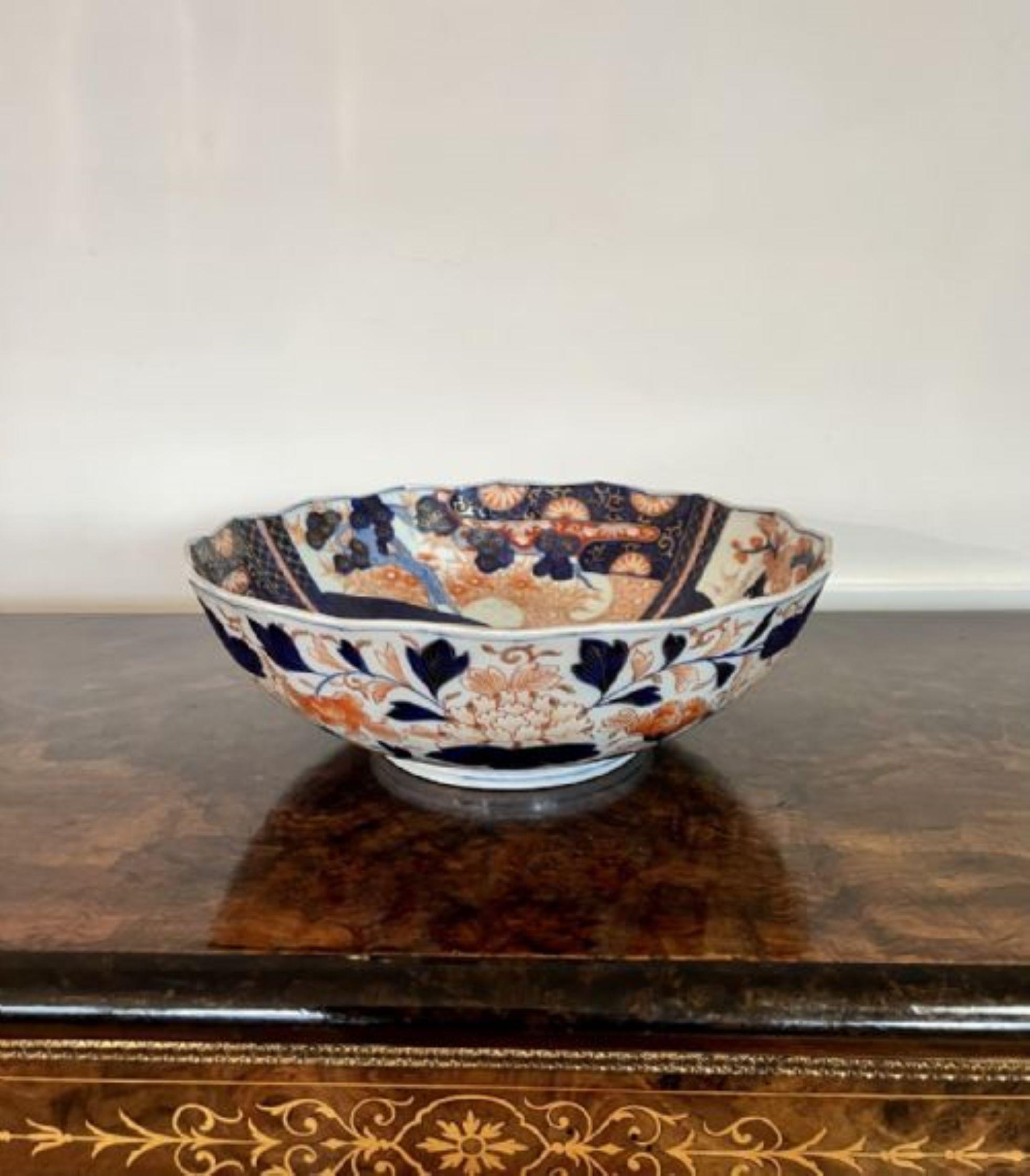 Quality antique Japanese Imari bowl having a scalloped shape edge with wonderful hand painted panels decorated with flowers and leaves in fantastic red, blue white and gold colours.