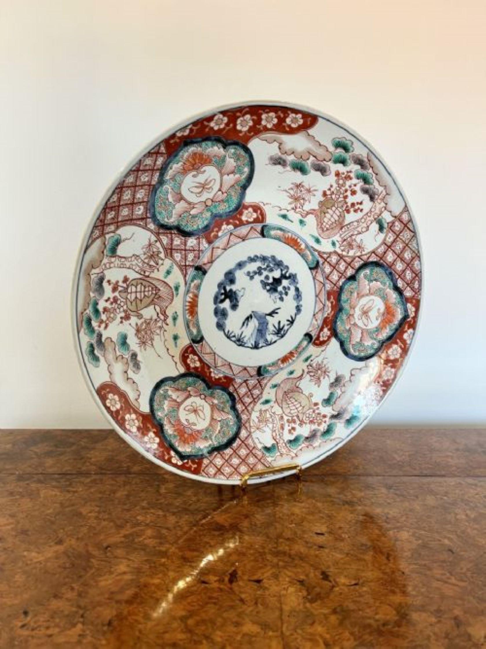 Quality antique Japanese Imari plate having a quality antique Japanese Imari charger having wonderful hand painted panels with flowers and foliage in red, blue, orange, green and white colours. 
