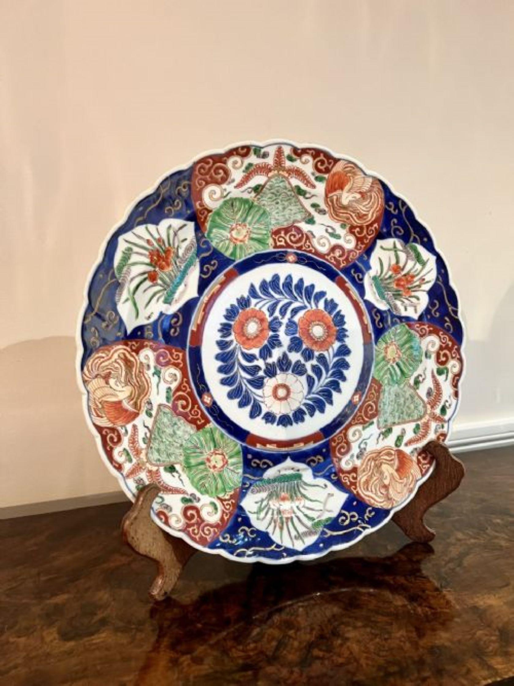 Quality antique Japanese Imari plate having a quality antique Japanese Imari charger with a wavy edge having wonderful hand painted panels with flowers and foliage in vibrant red, blue, orange, gold and white colours. 