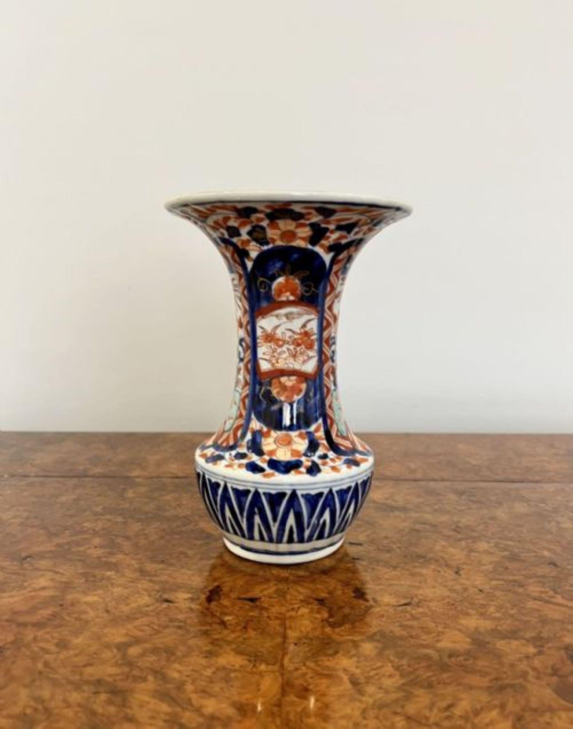 Quality antique Japanese Imari fluted shaped vase, having a quality Japanese Imari vase hand painted in wonderful red, blue, orange and white colours decorated with flowers, leaves and scrolls 