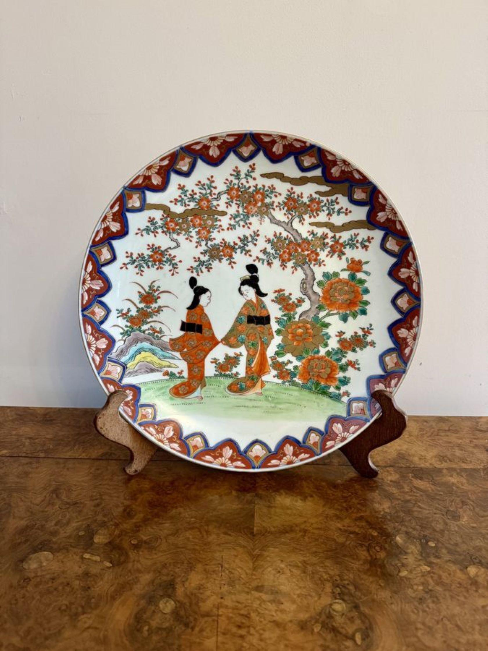 Quality antique Japanese imari large plate, having a quality antique Japanese imari plate decorated with traditional figures, trees and flowers within a floral border hand painted in wonderful red, green blue, white and gold colours.

D. 1920
