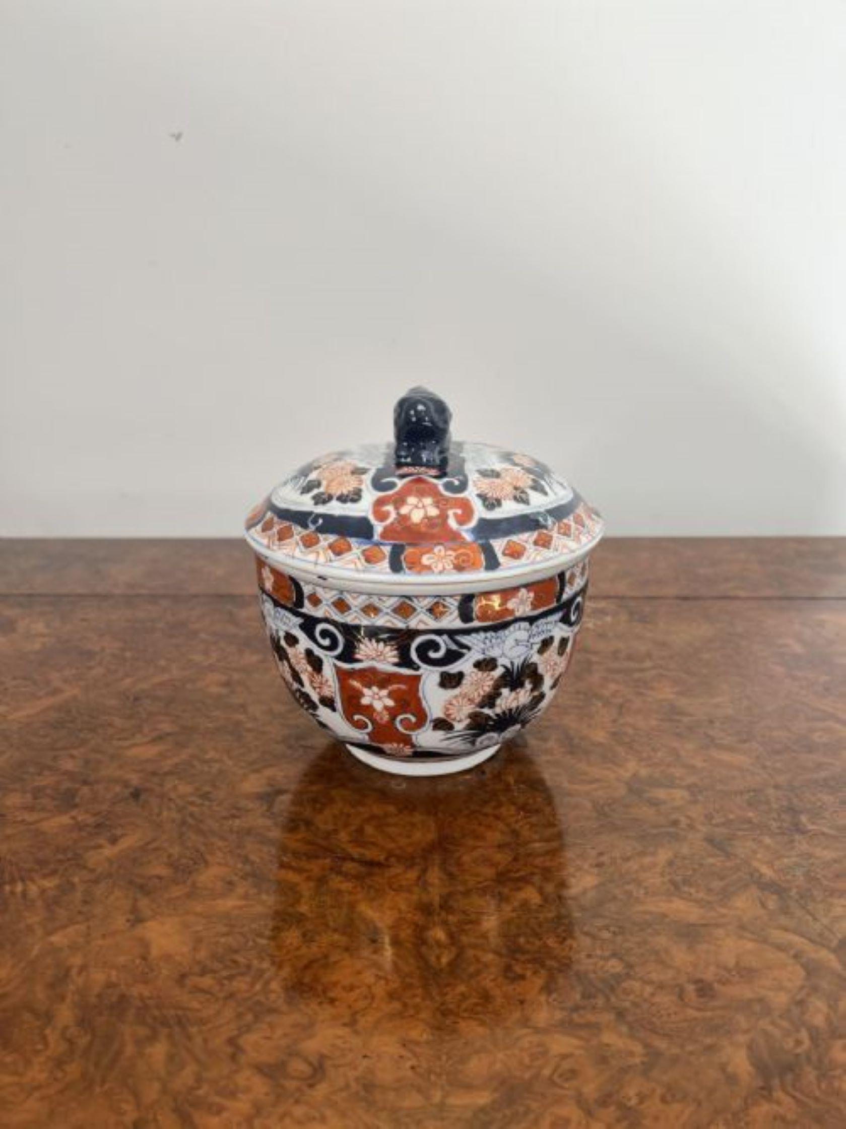 Quality antique Japanese imari lidded jar having a quality antique Japanese imari lidded jar with wonderful hand painted decoration in blue, red, white and gold colours decorated with flowers, trees and scrolls, having a removable lid with a dog of