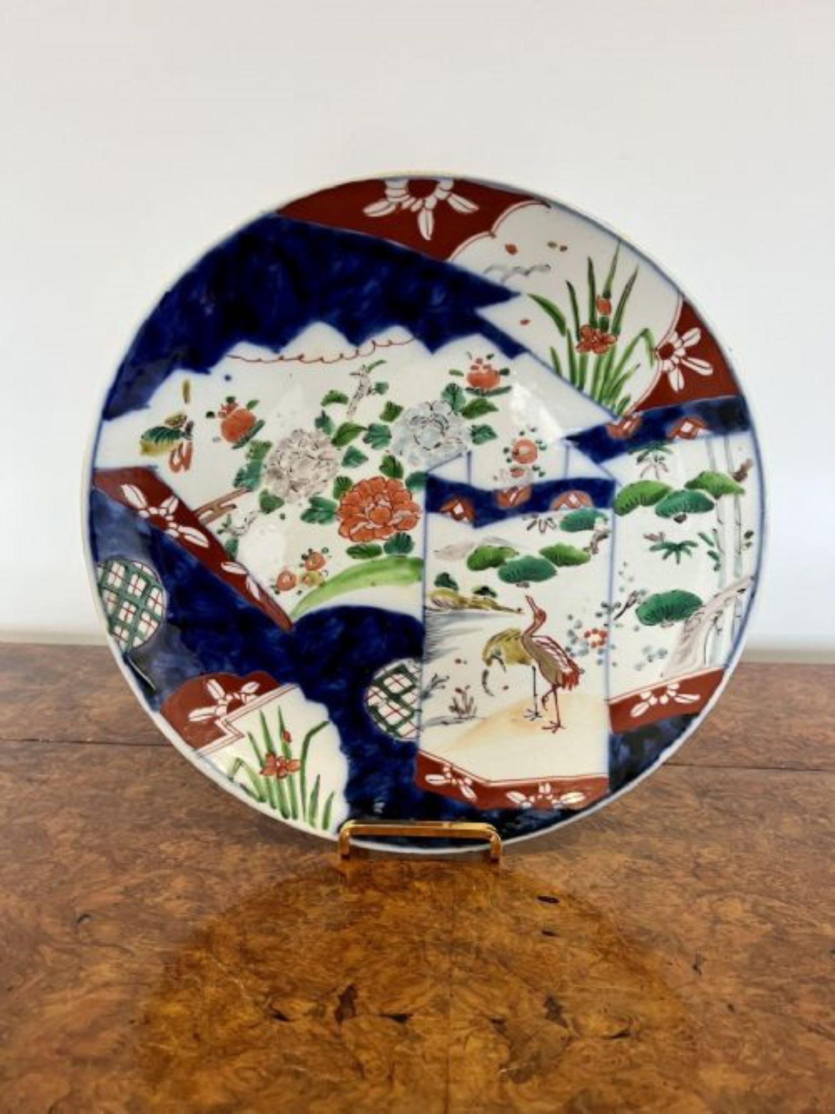 Quality antique Japanese Imari plate having a quality antique Japanese Imari plate decorated with birds and flowers hand painted in vibrant red, green, blue and white colours. 