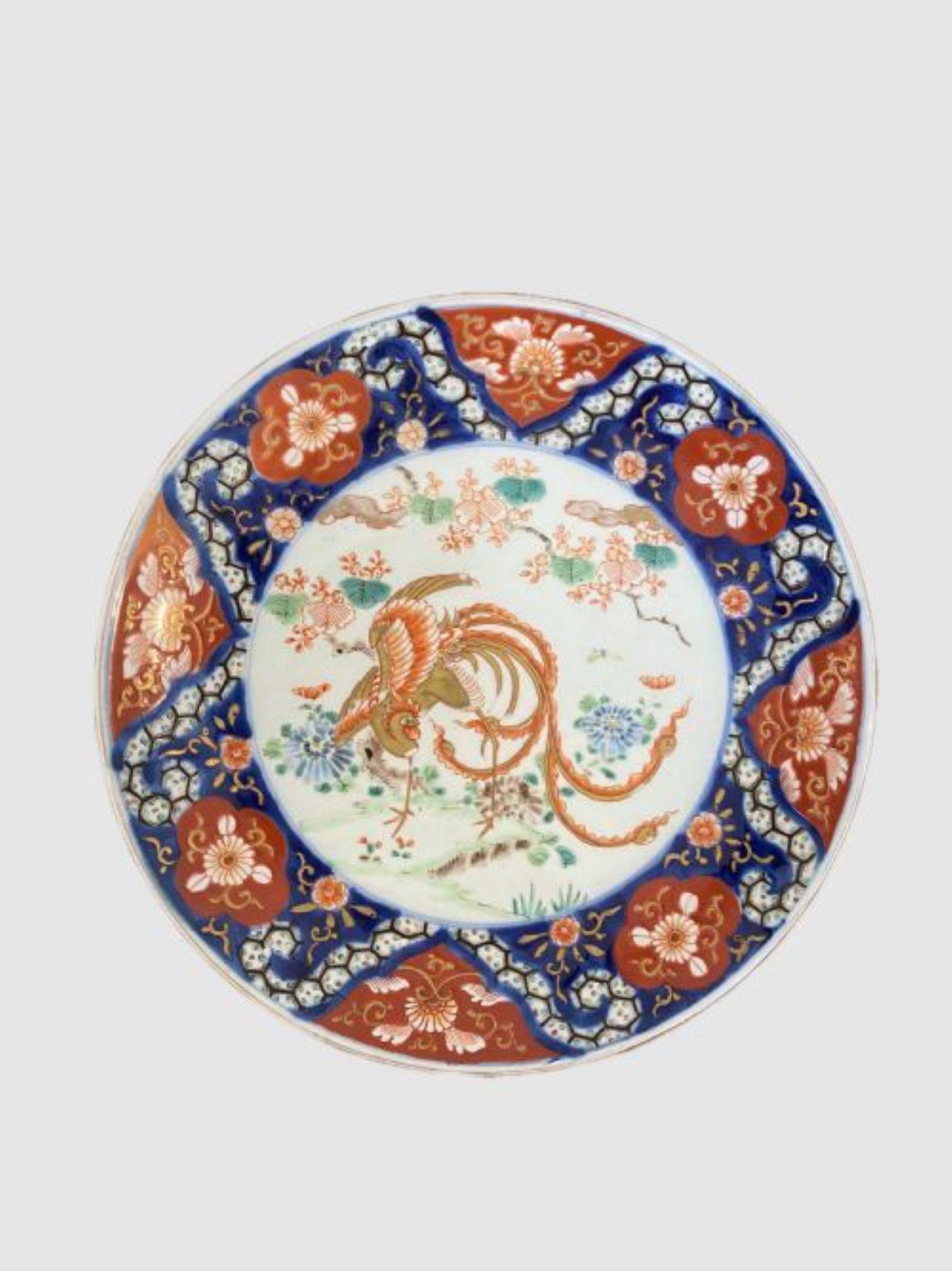 Assiette imari japonaise ancienne de qualité Assiette imari japonaise ancienne de qualité peinte à la main avec des fleurs, des feuilles, des arbres et un grand oiseau décoré inhabituel au centre dans de magnifiques couleurs rouge, bleu, vert, blanc