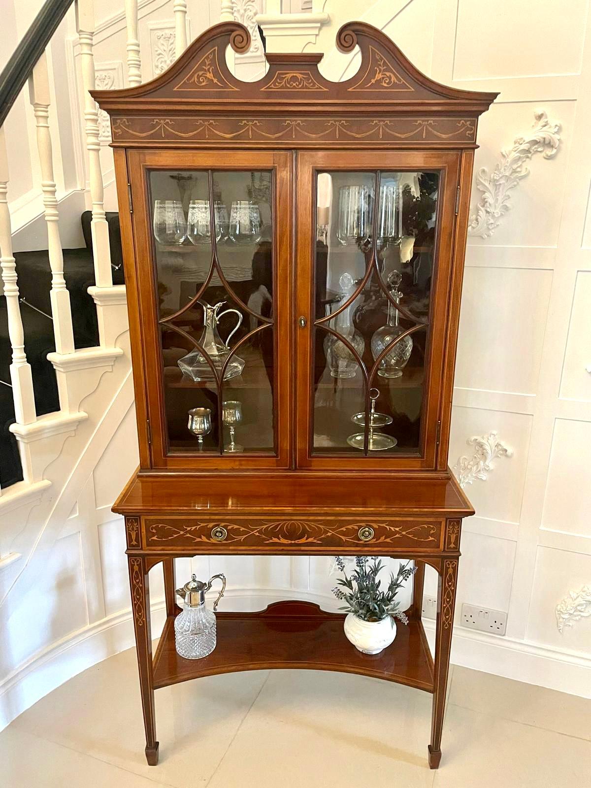 Fine quality antique Victorian mahogany inlaid display cabinet by Edwards and Roberts having a quality mahogany swan neck pediment with satinwood inlay above an inlaid frieze with swags and bows above a pair of astral glazed doors opening to reveal