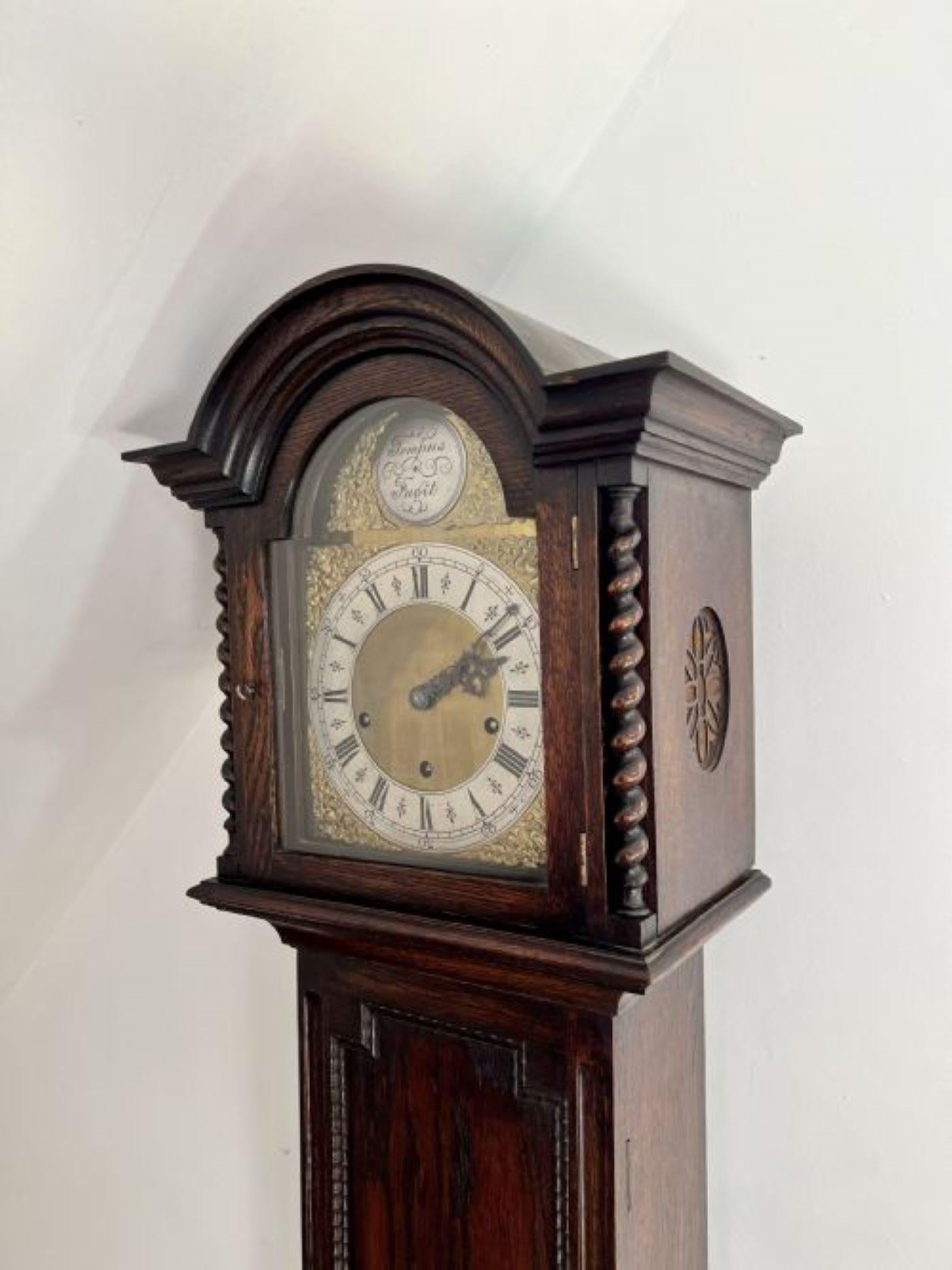 Quality Antique Oak eight Day Chiming Grandmother Clock having a quality oak case with carved mouldings and fine barley twist columns, with an ornate dial and a arched brass face with ornate spandrels and inscribed 'Tempus Fugit' with the original