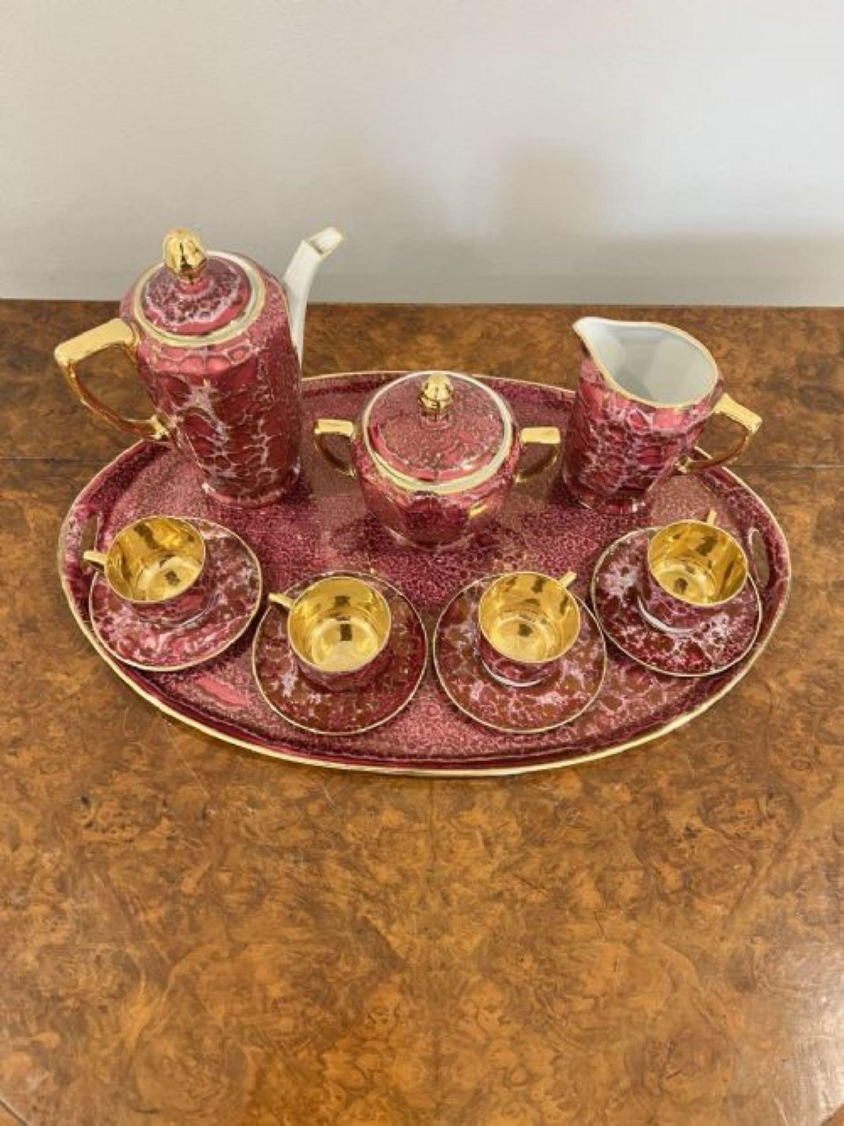 Quality antique porcelain coffee set consisting of an oval tray, four coffee cups and saucers, a coffee pot, cream jug and sugar bowl in wonderful pink and gold colours 