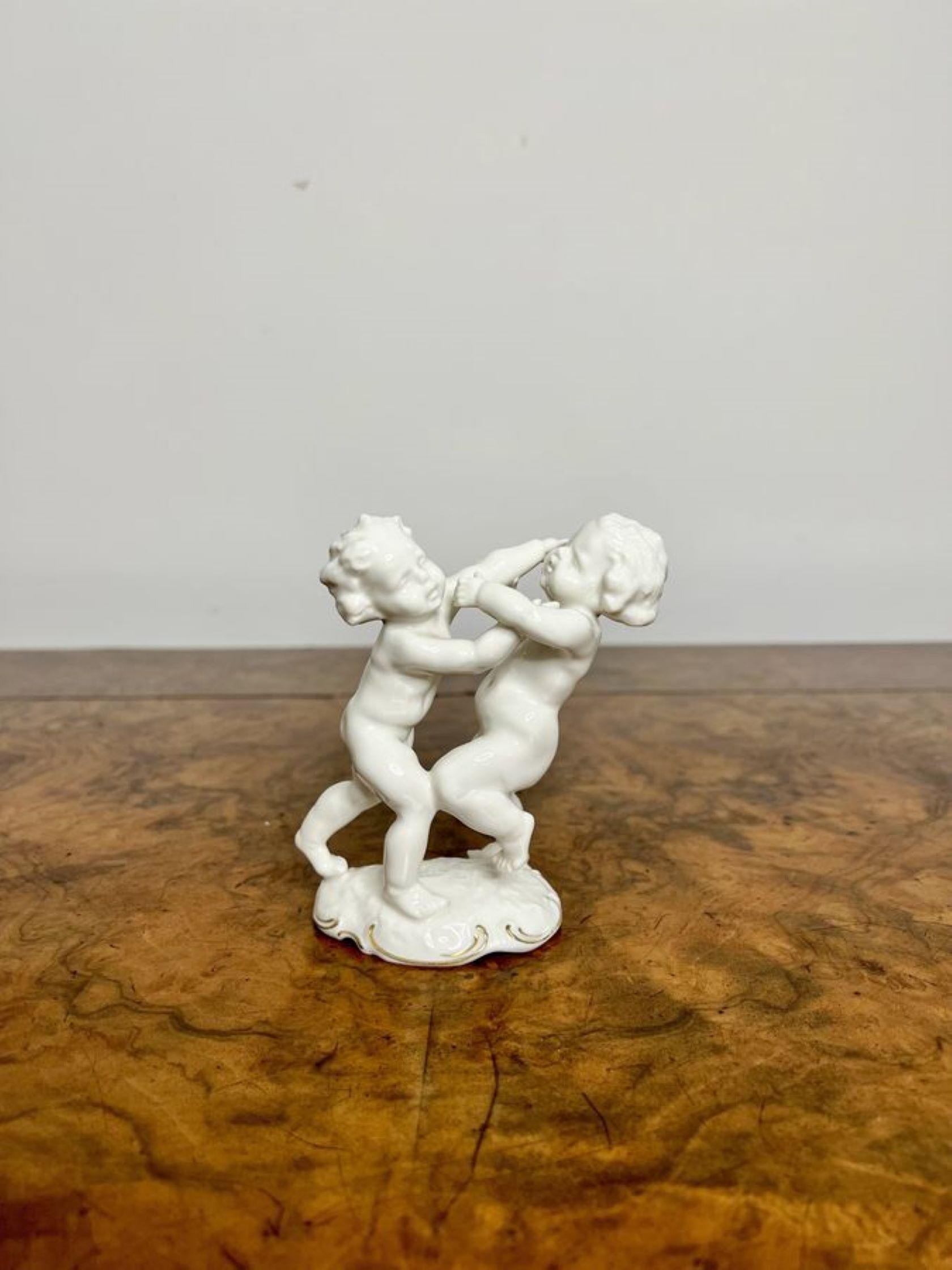 Quality antique porcelain group by Karl Tutter having a Hutschenreuther model of two cherubs wrestling a shaped gilded base.
Stamp to base.

D. 1930