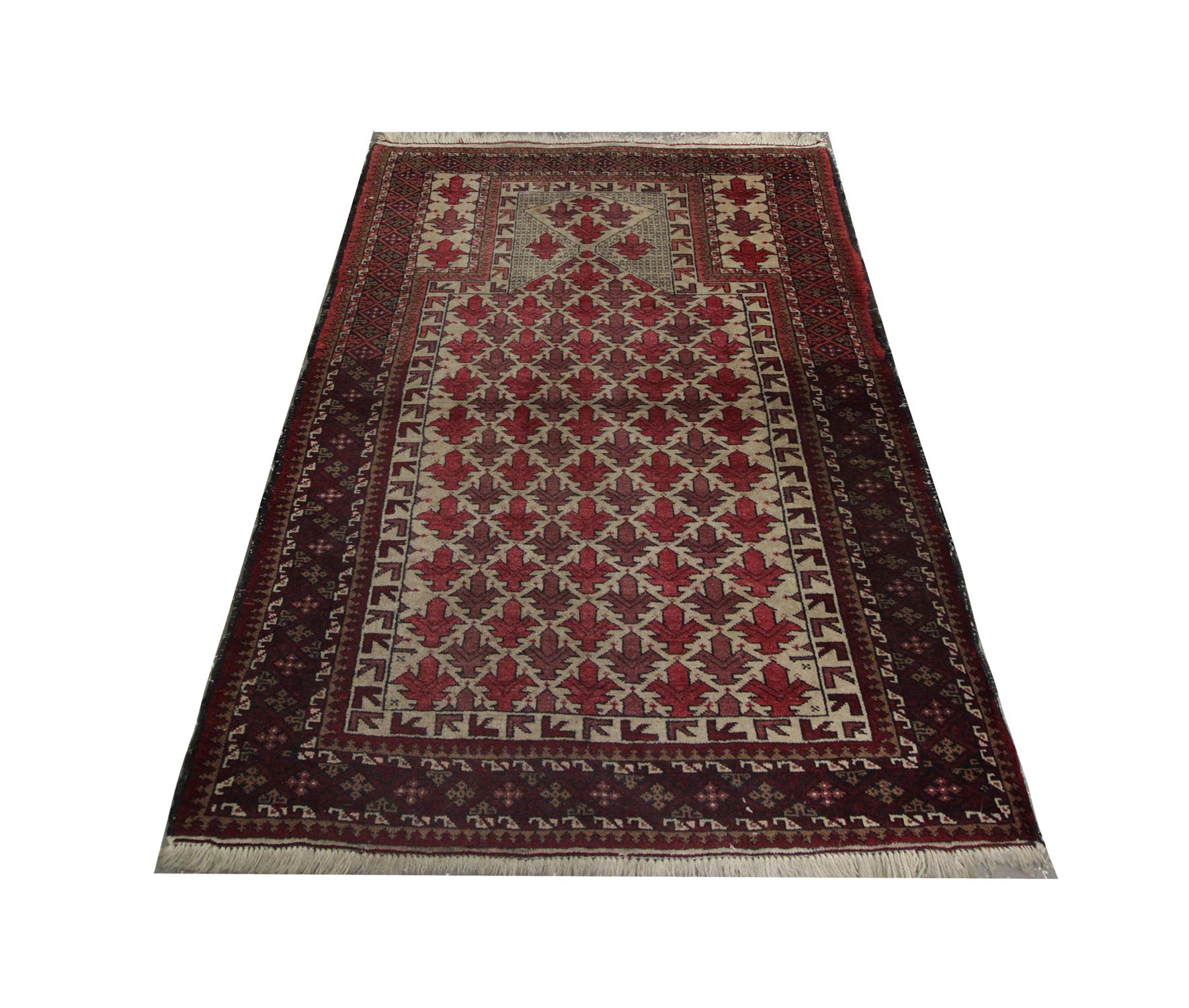 Deep reds have been used as the primary colours into this high-quality handmade carpet Antique Afghan rug, with a highly detailed repeat pattern design that was hand-woven in 1940 with hand-spun, vegetable-dyed wool, and cotton, by some of the