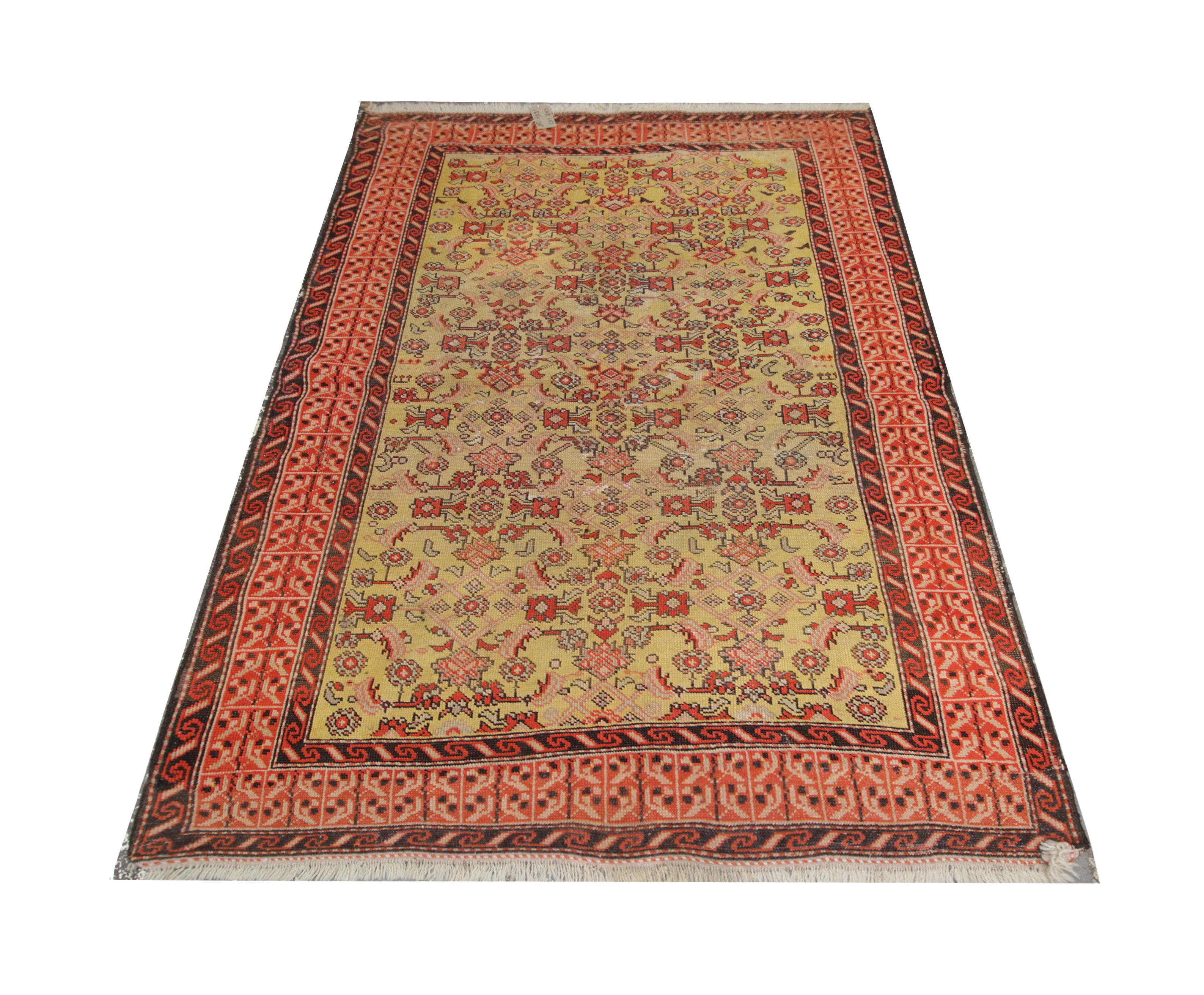 Yellow and red have been woven into a highly-detailed design in this antique rug Caucasian area rug, hand-woven in Azerbaijan in 1940. The Karabagh rug features a stunning central design woven on a yellow background with floral patterns in a
