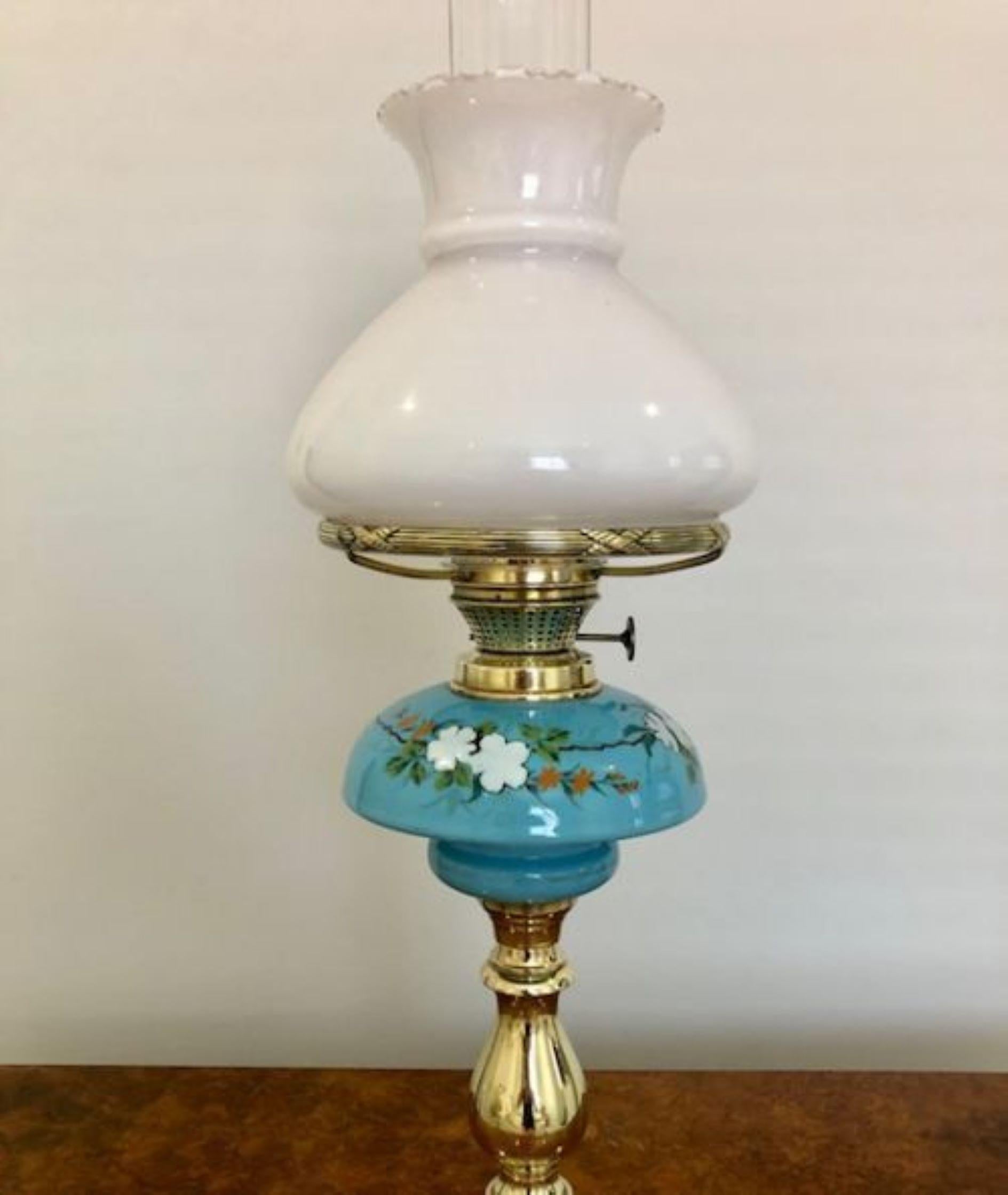 Quality antique Victorian brass oil lamp having the original white glass shade with a blue ceramic reservoir  supported by an ornate brass column 