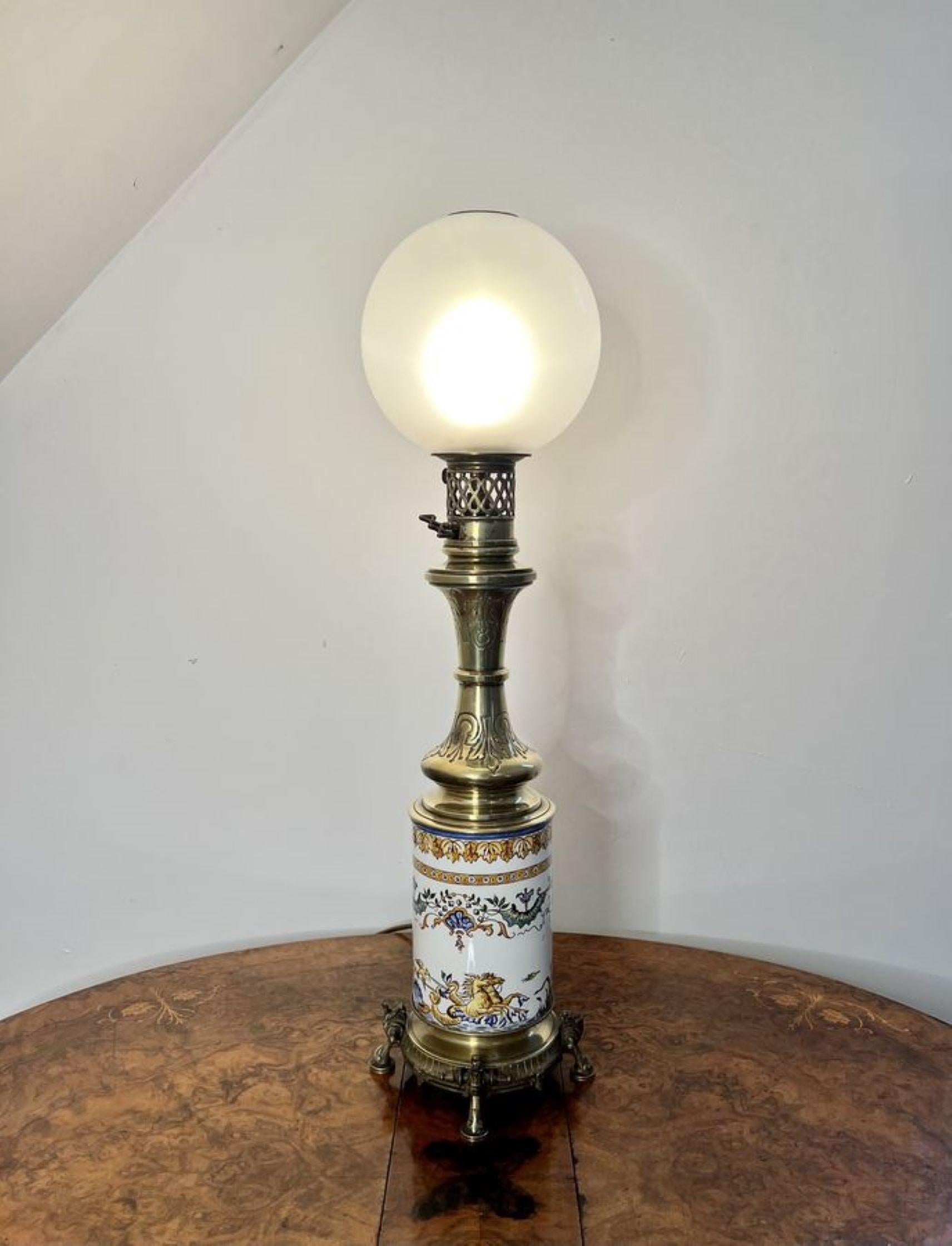 Quality antique Victorian ceramic and brass lamp, having a fantastic ceramic base decorated with sea creatures, birds, scrolls and leaves on a white ground hand painted in blue, yellow, green and brown colours, raised on four brass ornate feet, a