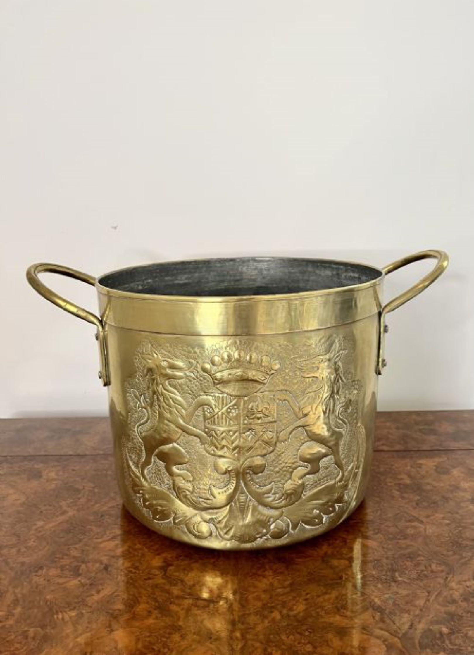 Quality antique Victorian circular brass coal bucket having a quality antique Victorian brass coal bucket decorated to the front with the coat of arms, with two handles to the sides and circular in shape.